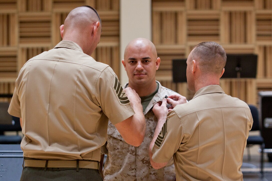 The Marine Band's new recording engineer Jeffrey Higgs is promoted to the rank of gunnery sergeant at a ceremony in John Philip Sousa Band Hall. (U.S. Marine Corps photo by Staff Sgt. Brian Rust/released)