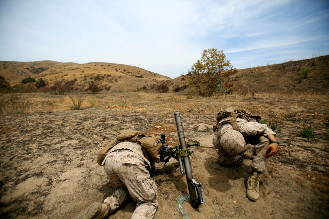 Marines with Company L, 3rd Battalion, 1st Marine Regiment, fire mortars in support of adjacent rifleman units aboard Camp Pendleton, Calif., July 29, 2014. The section of mortars was part of a five-day live-fire range to test the unit's capabilities to conduct a squad-sized attack on simulated enemy positions.