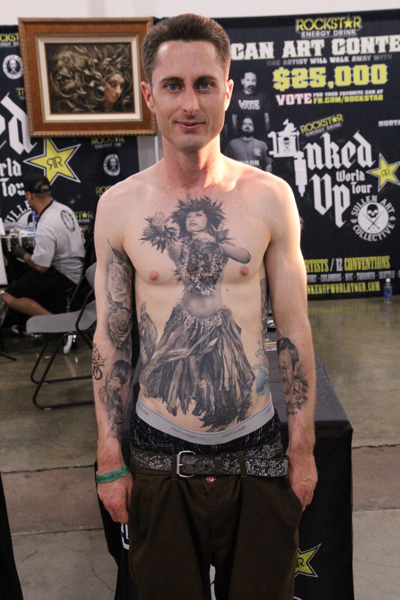 A man (military affiliation unknown) poses for a photo displaying a Hawaiian-themed tattoo on his torso at the Pacific Ink & Art Expo, Blaisdell Exhibition Hall, Honolulu, Hawaii, Aug. 3, 2013. According to the May issue of Military History Monthly, hula girl tattoos hula girls are "synonymous with the sailing lifestyle, representing the allure of distant lands and the mystery of indigenous female natives." All branches of the service have allow tattoos depicting human figures as long as they do not advocate sexual, racial, ethnic, or
religious discrimination. (U.S. Air Force photo by Tech. Sgt. Phyllis Keith)