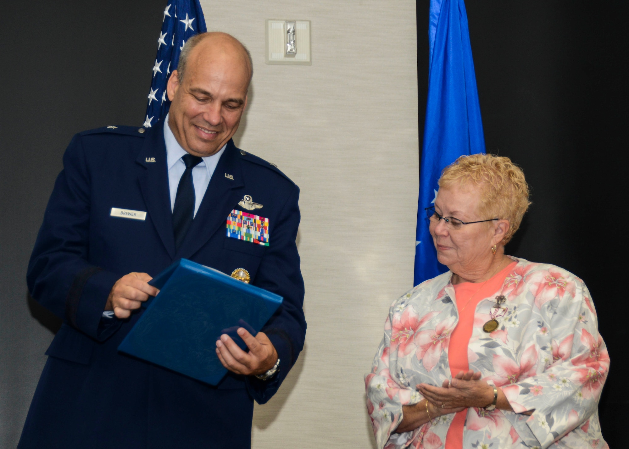 Brig. Gen. Michael Brewer, 412th Test Wing commander, presented Sandra Sergent , 412th Logistics Readiness Squadron director, with a series of letters of appreciation, honoring her 45-year civil service career Aug. 1. (U.S. Air Force photo by Rebecca Amber) 