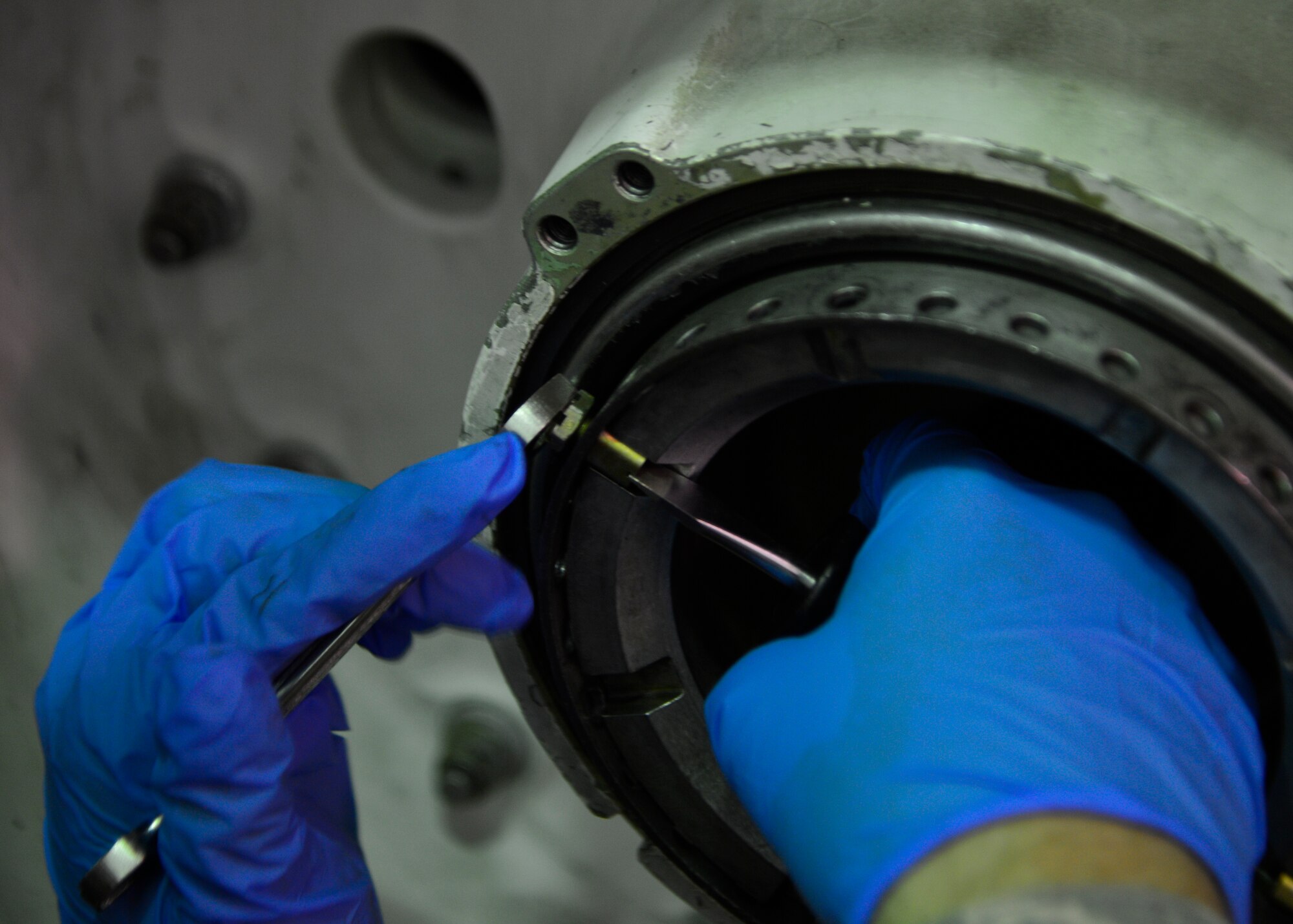 Airman Eric O’Connor, 373d Training Squadron student, removes a through bolt while training on a C-5M Super Galaxy main landing gear trainer July 28, 2014, at Dover Air Force Base, Del. Students train on how to remove aircraft tires from the axle and inspect them. (U.S. Air Force photo/Airman 1st Class William Johnson)