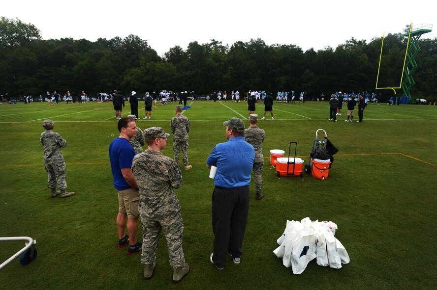 Team Shaw members stand on the practice field during the Carolina Panthers training camp in Spartanburg, S.C., July 31, 2014. The Airmen and soldier watched the Panthers run drills, as well as received autographs at the end of the practice. (U.S. Air Force photo by Airman 1st Class Jensen Stidham/Released)