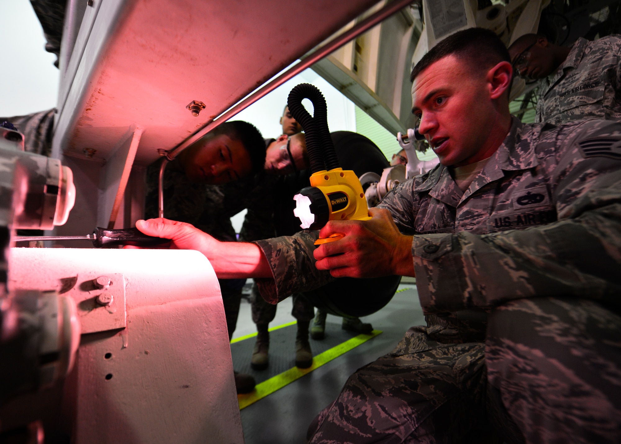 Staff Sgt. Chace Layton, 373d Training Squadron C-5 mission ready Airmen instructor, shows his students how to engage a brake lock assembly on a C-5M Super Galaxy main landing gear trainer July 28, 2014, at Dover Air Force Base, Del. The simulator provides students with a realistic C-5M landing gear platform to train on. (U.S. Air Force photo/Airman 1st Class William Johnson)