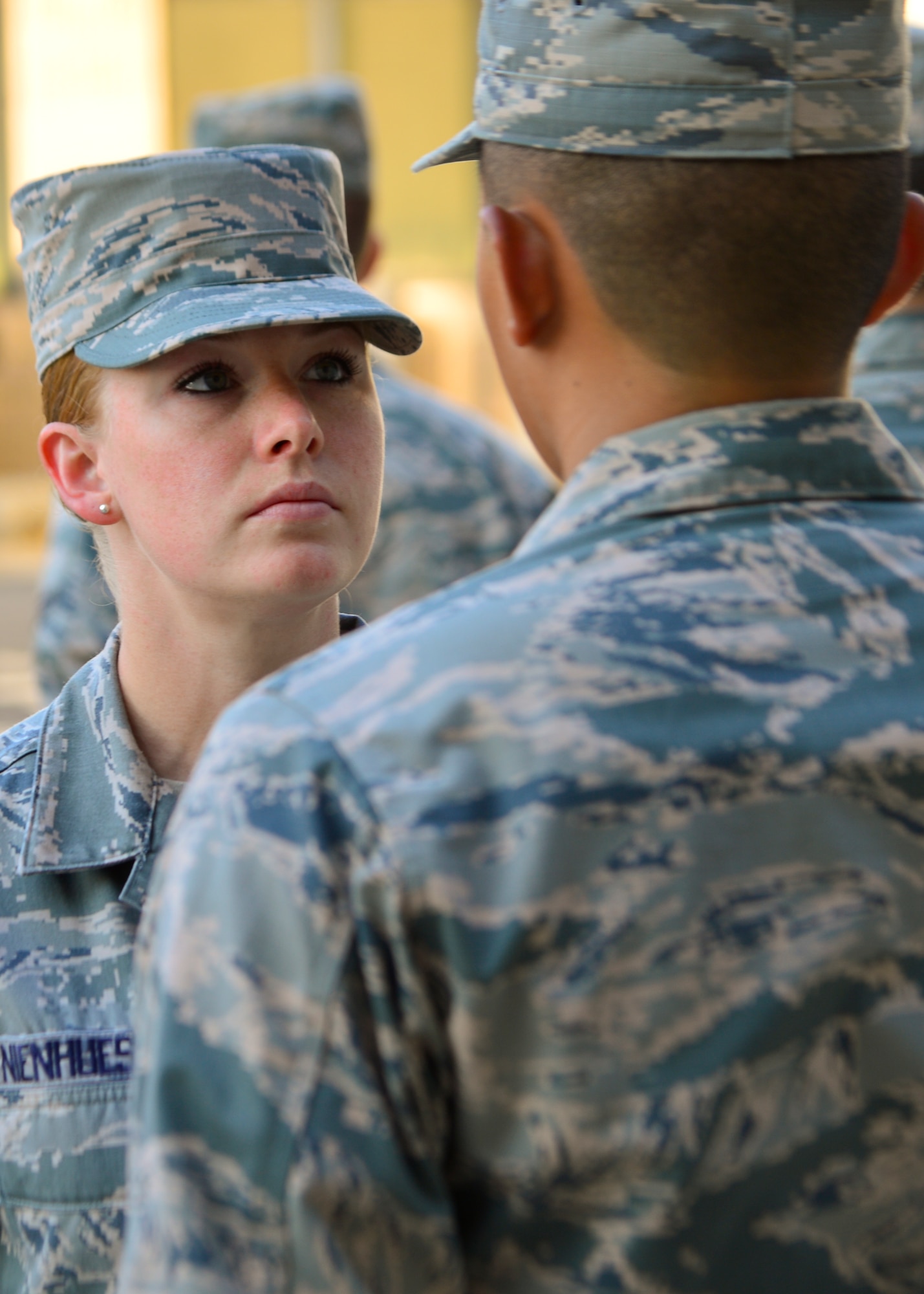 Staff Sgt. Jessica Nienhueser, 373d Training Squadron military training leader flight chief, inspects Airman Renald Rivera, 373d TRS student, during an open ranks inspection July 28, 2014, at Dover Air Force Base, Del. Airmen in technical training are expected to meet the grooming and uniform standards they learned in basic military training. (U.S. Air Force photo/Airman 1st Class William Johnson)