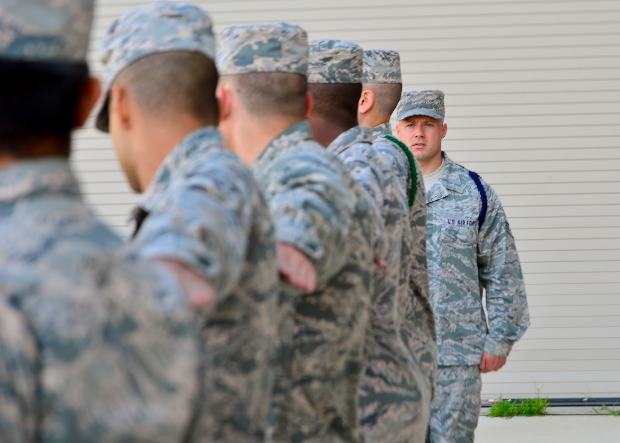 Staff Sgt. Zachary Replogle, 373d Training Squadron military training leader, inspects an element during an open ranks inspection July 28, 2014, at Dover Air Force Base, Del. Airmen assigned to the 373d TRS perfect drill movements that they learned in basic military training while attending their technical training. (U.S. Air Force photo/Airman 1st Class William Johnson)