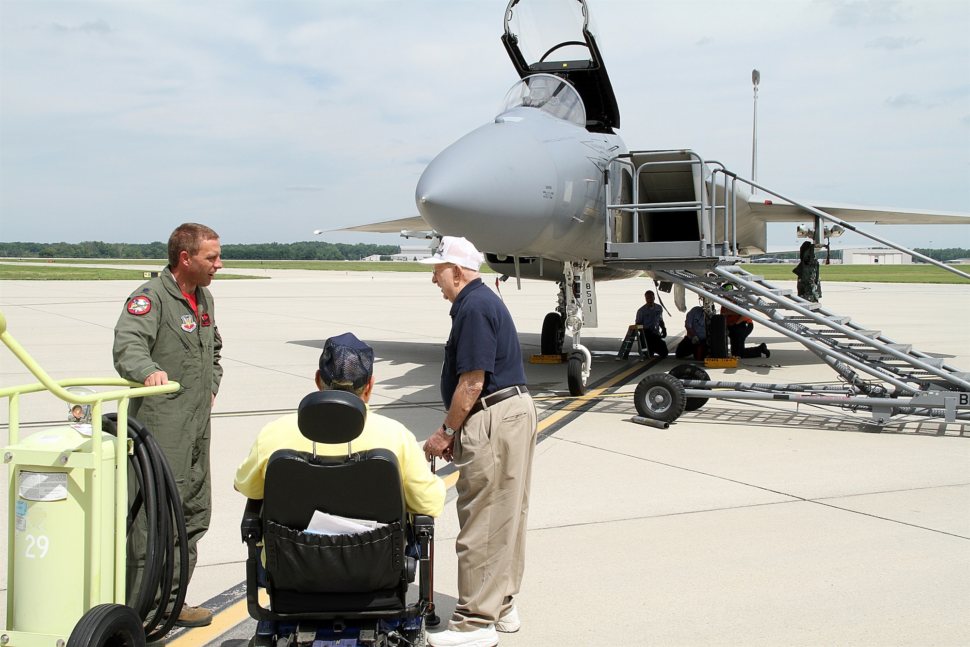 Lt. Col. Morris Fontenot Jr., 104th Operations Group, Barnes Air National Guard Base, chats July 25 with Bob Gobble of Beavercreek (seated), who worked from 1971 to 1992 on the F-15 and has served as a spokesperson for the Gathering of Eagles for 11 years, and Ed Horn of Pam beach Gardens, Fla. Horn, 89, was an F-15 consultant and worked at Wright-Patterson AFB for 30 years after serving as a B-26 bomber pilot during WWll and being held as a prisoner of war in Germany and Poland. (Skywrighter photo by Kathy Tyler)