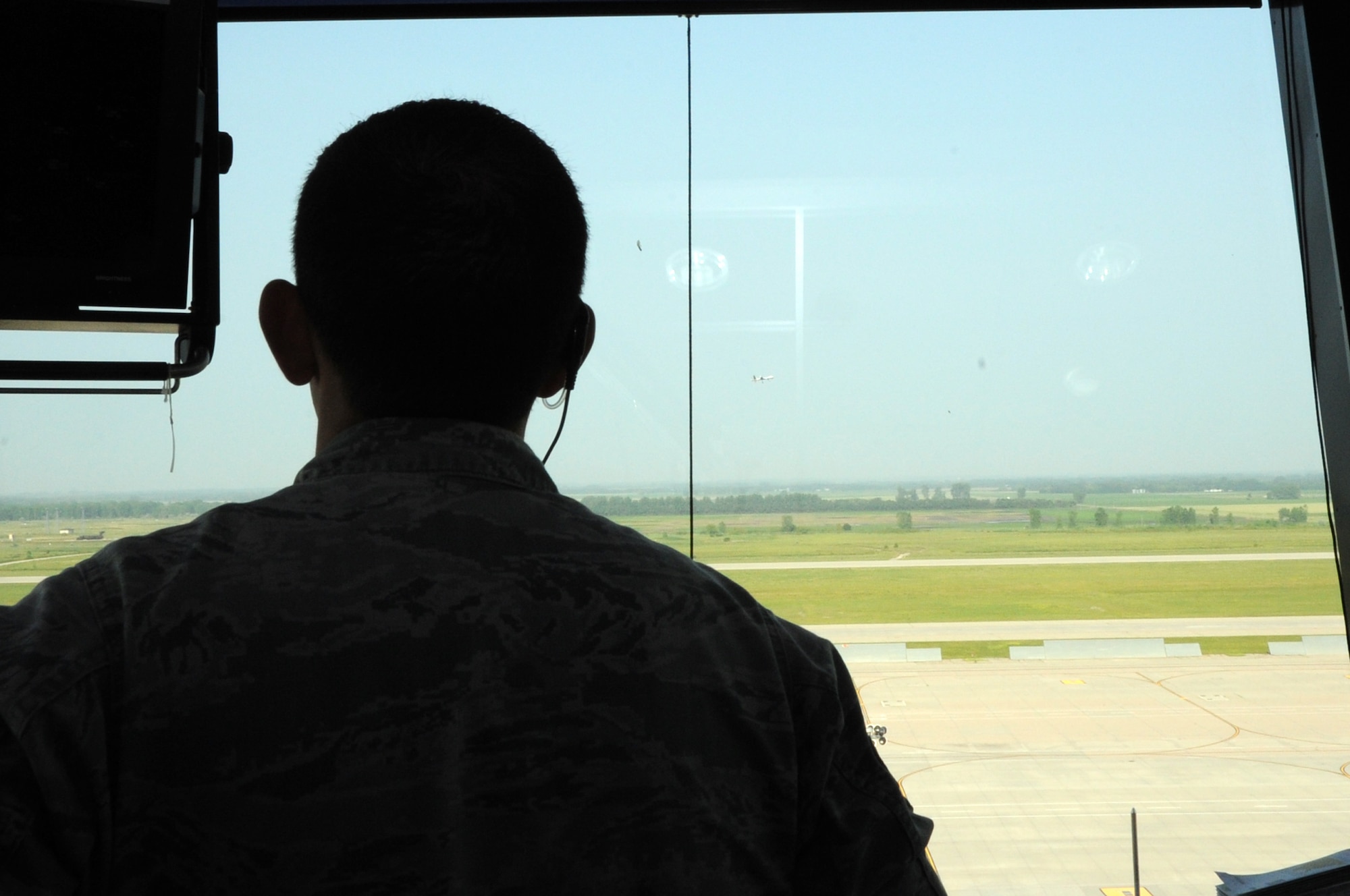 Senior Airman Kyle Thwing, 319th Operations Support Squadron air traffic controller, watches an RQ-1 Predator take off from the Grand Forks Air Force Base, N.D., runway August 1, 2014. The Predator was part of the first flight of unmanned aerial vehicles in unrestricted airspace in the United States. (U.S. Air Force photo/Staff Sgt. David Dobrydney)