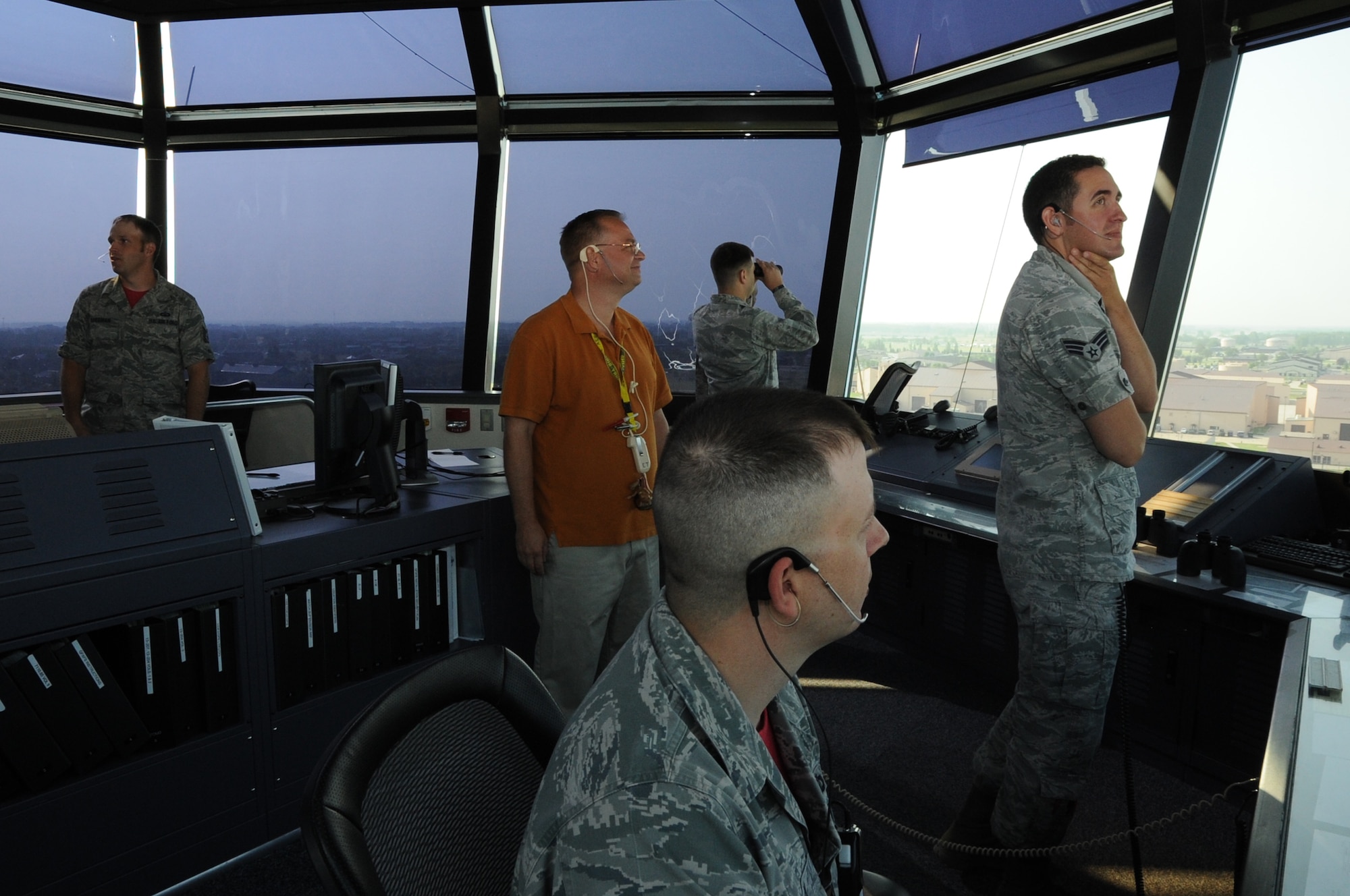 Members of the 319th Operations Support Squadron monitor aircraft movements from the air traffic control tower on Grand Forks Air Force Base, N.D., August 1, 2014. The flights they are monitoring were the first flights of unmanned aerial vehicles in unrestricted airspace. (U.S. Air Force photo/Staff Sgt. David Dobrydney)