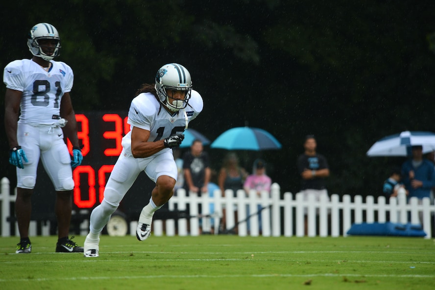 A Carolina Panthers football player runs a passing drill during training camp in Spartanburg, S.C., July 31, 2014. Throughout the day, five Team Shaw members watched the training as well as ate lunch with the players after the practice. (U.S. Air Force photo by Airman 1st Class Jensen Stidham/Released)