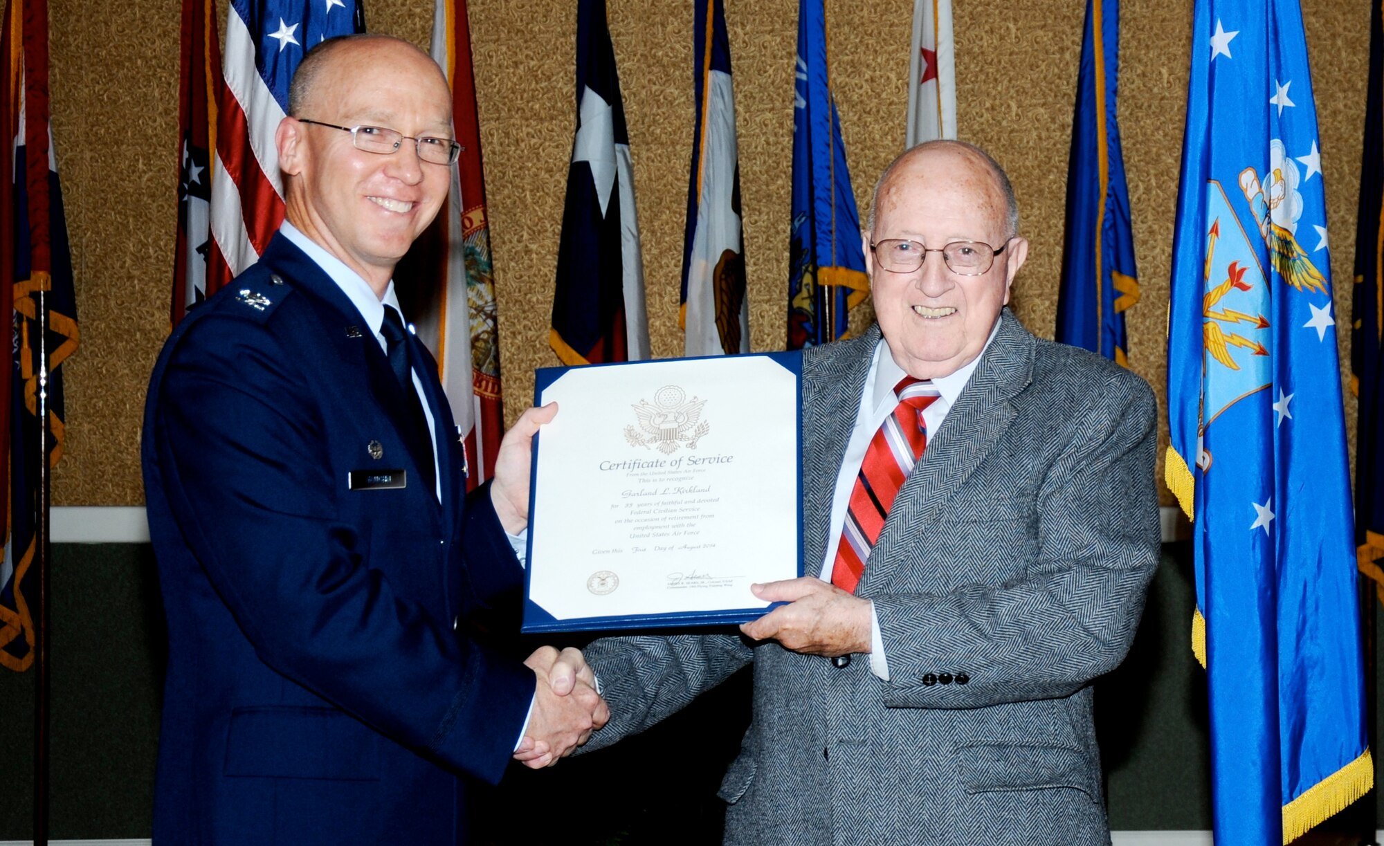 Col. Scott Vaughn, 14th Mission Support Group Commander, hands a Certificate of
Service to Garland Kirkland, 14th Force Support Squadron Staffing Specialist, during
his retirement in the Columbus Club, July 30. Kirkland began his service three days
after his 17th birthday, and now ends his service 57 years later culminated 24 years in
uniform and 33 years as an Air Force civilian.(U.S. Air Force photo/ Sharon Ybarra)