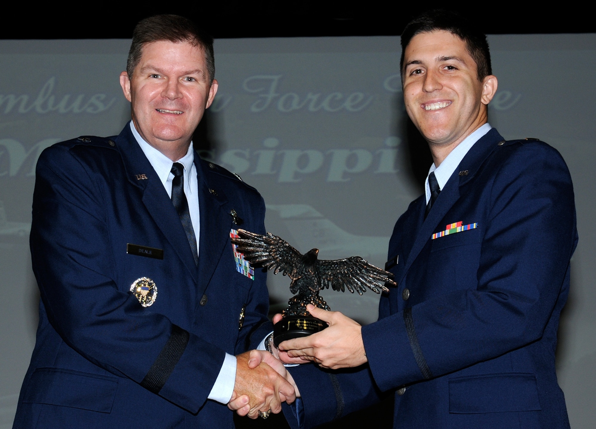 Brig. Gen. Thomas Deale, Air Command and Staff College Commandant and Spaatz
Center for Officer Education Vice Commander, presents 2nd Lt. Ryan Luersen with an
Air Education and Training Command Commanders Trophy and Distinguished Graduate Award. Deale shared with the graduates his own personal combat stories, and what got him through challenges he faced while flying.(U.S. Air Force photo/Melissa Doublin)