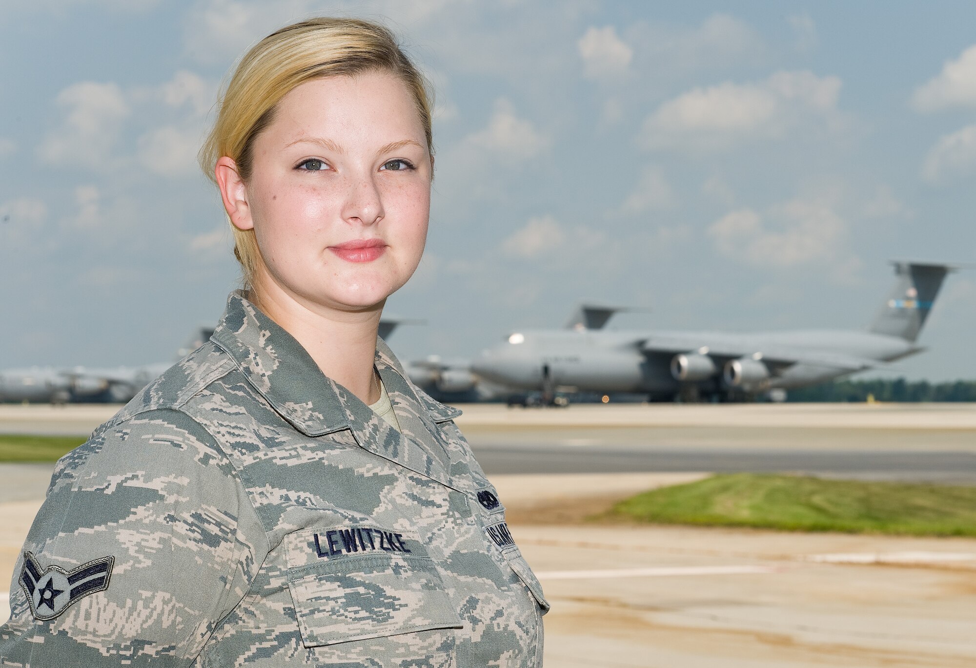 Airman 1st Class Alexis Lewitzke, 436th Maintenance Squadron C-5 aerospace maintenance journeyman poses for a photo July 31, 2014, at Dover Air Force Base, Del. Lewitzke was randomly selected for The Airlifter's feature "A face of Team Dover: Vol. 1, No. 1." (U.S. Air Force photo by Roland Balik)
