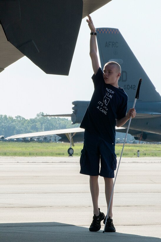 A student from the Louisiana Center for the Blind, checks the height of the wing on a 307th Bomb Wing B-52H Stratofortress during a tour on July 30, 2014, Barksdale Air Force Base, La. The Center provides instruction in Braille, computer literacy, industrial arts, cane travel, independent living skills, home economics, as well as job development and General Education Development and remedial education assistance. (U.S. Air Force photo by Master Sgt. Greg Steele/Released)