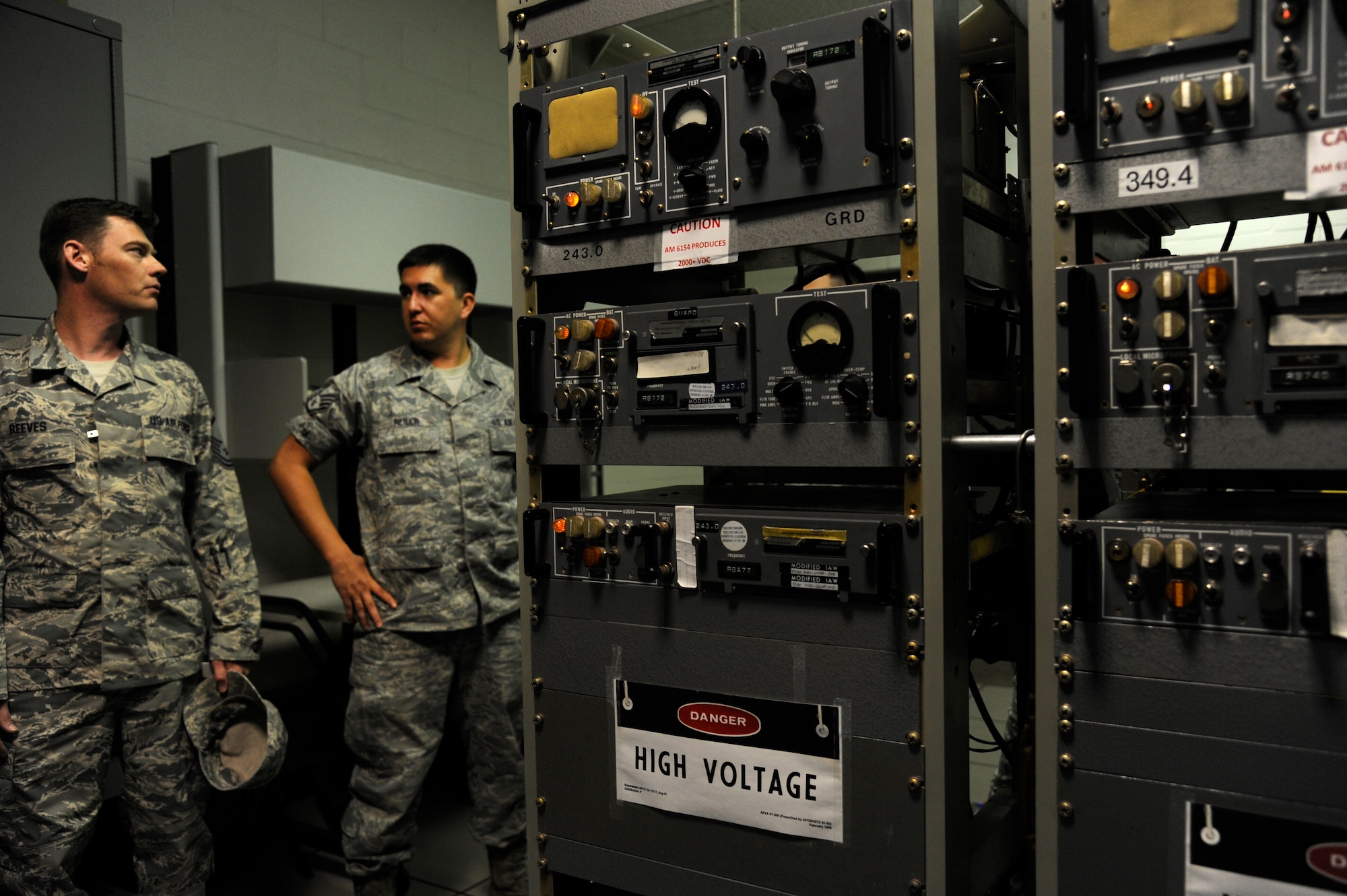 MSgt. Randy Reeves, 375th Operations Support Squadron NCO in-charge of airfield systems, and SSgt. David Reiler, 375th OSS assistant NCOIC of airfield systems, discuss ground-to-air radio maintenance at Scott Air Force Base, Ill., July 29, 2014. The ground-to-air radios are used by the air traffic control tower for controlling air and ground traffic in support of Scott's flying operations. (U.S. Air Force photo/Angelina Casarez)