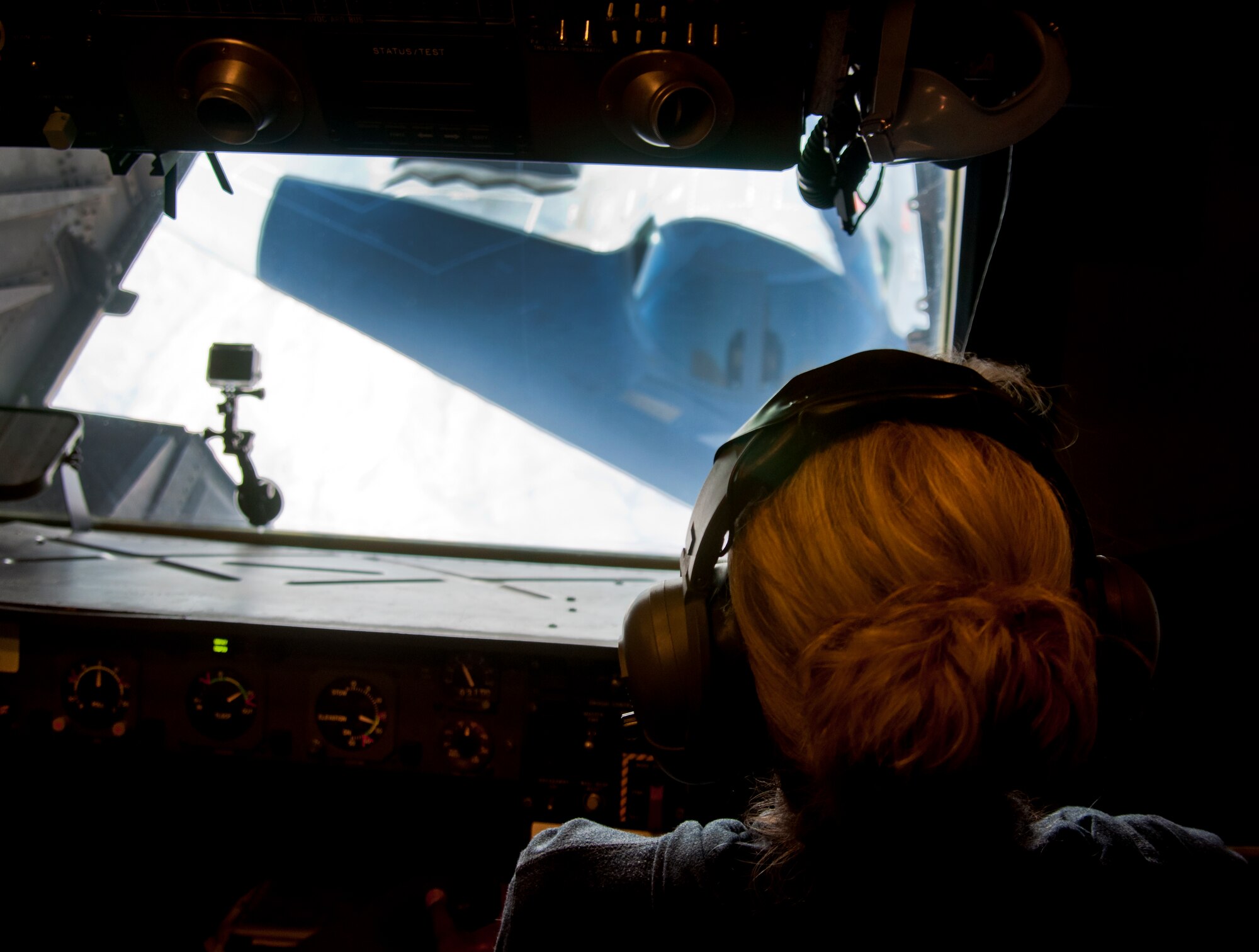 Natalie Thomas, 9th Air Refueling Squadron unit program coordinator, looks on as a B-2 Spirit conducts an aerial refuel with a KC-10 Extender July 23, 2014. (U.S. Air Force photo by Senior Airman Charles Rivezzo)