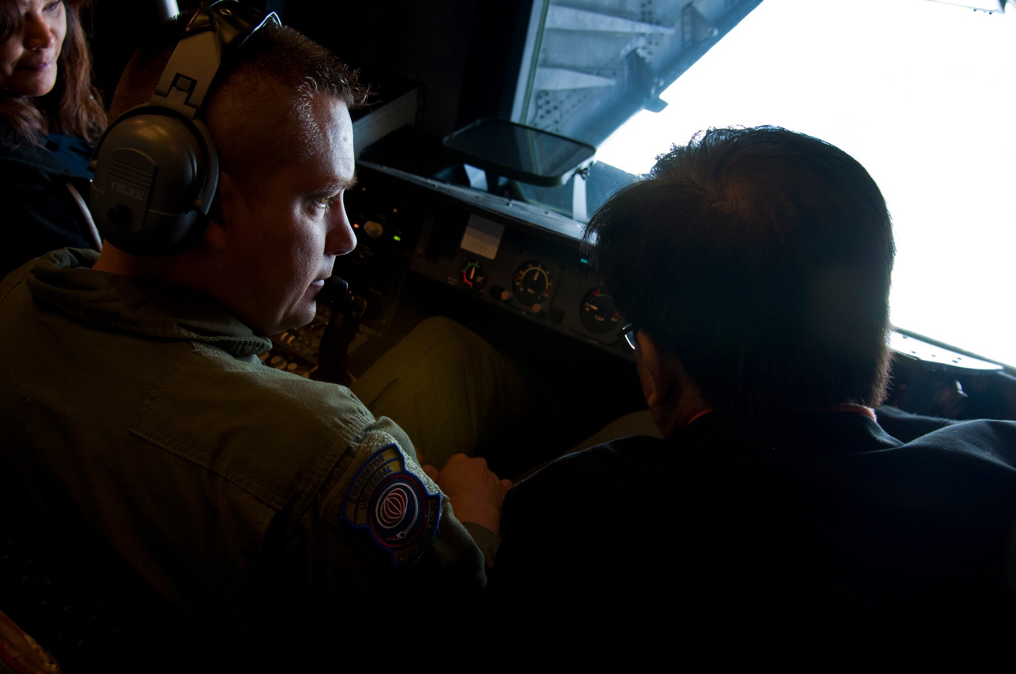 Senior Master Sgt. Shane Hickman, 9th Air Refueling Squadron, instructs civilians onboard a KC-10 Extender on the duties performed by the boom operator July 23, 2014. (U.S. Air Force photo by Senior Airman Charles Rivezzo)
