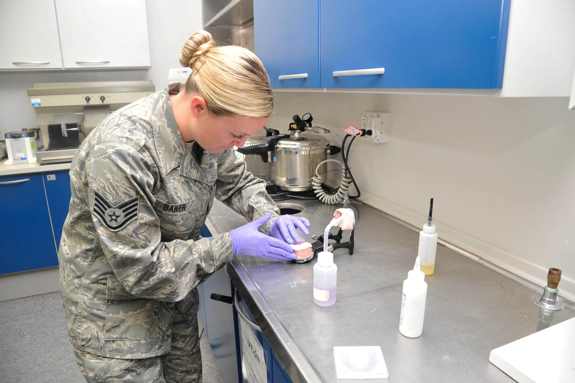 Staff Sgt. Maddie Baker, 56th Dental Squadron Dental Laboratory technician, carefully molds acrylic around a cast in the dental lab at Luke Air Force Base. The Airmen at the dental lab are responsible for fabricating crowns, retainers, sports guards, implants and more. (U.S. Air Force photo/Senior Airman Grace Lee)