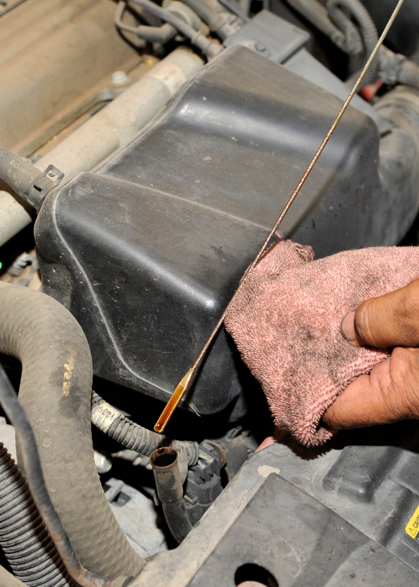 Regularly checking the oil of personal vehicles may help to prevent issues that could leave a person stranded in the heat of the desert. From the large dust storms, monsoon downpours and scorching heat of the desert sun, a car takes the brunt of the punishment during the summer. (U.S. Air Force photo/Senior Airman Marcy Copeland)