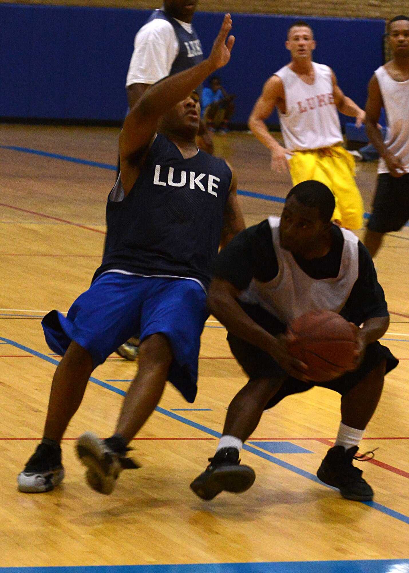 Koraye Williams, 56th Comptroller Squadron playing on the 56th Fighter Wing Staff Agencies team, backs down a defender during an intramural basketball game against 56th Logistics Readiness Squadron July 21 at Luke Air Force Base. FWSA won the game in overtime 72-69. (U.S. Air Force photo/Senior Airman Devante Williams)