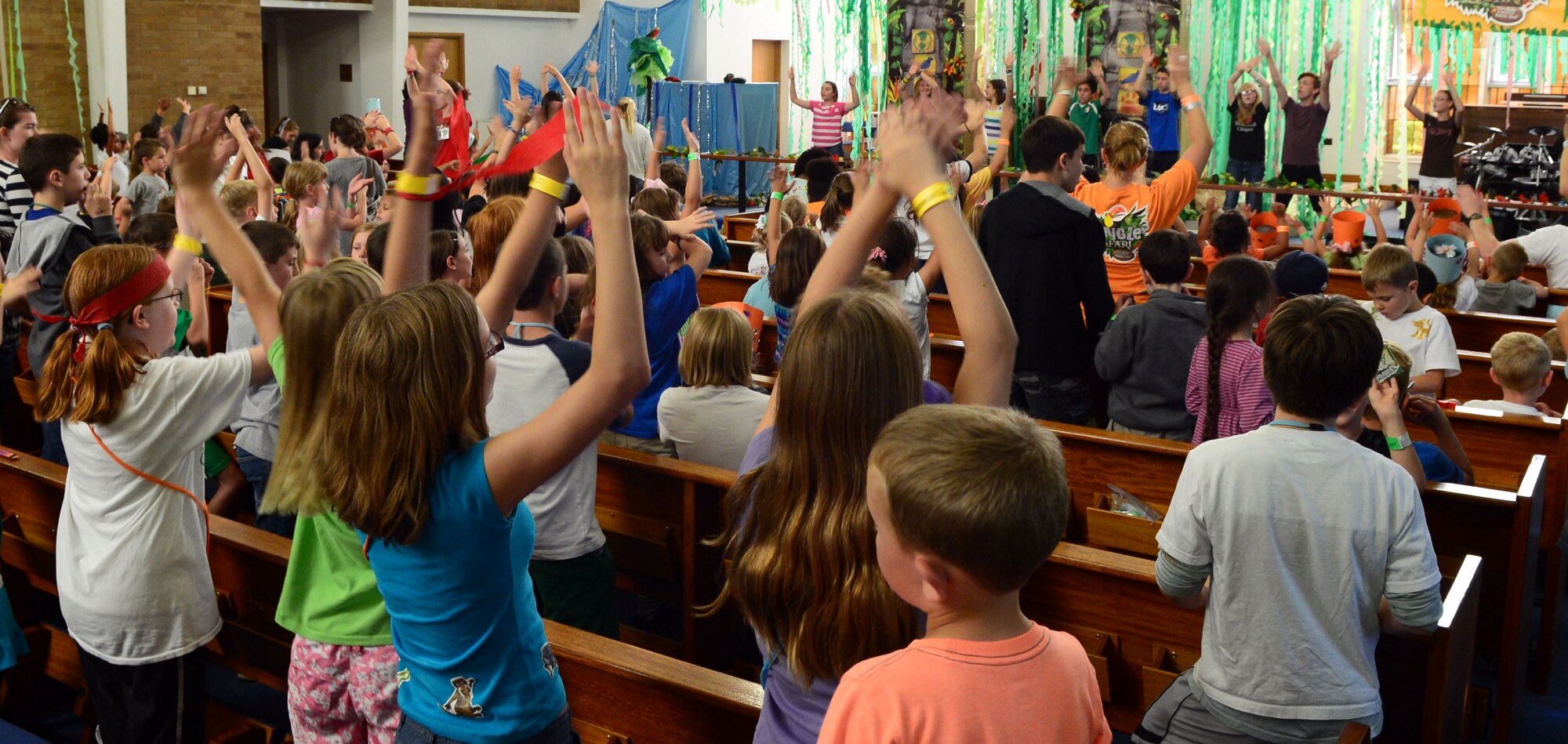 The RAF Mildenhall Vacation Bible School drama team leads Team Mildenhall children in song Aug. 1, 2014 at the base chapel. The week-long school offered children a change to gather together, socialize and have fun. (U.S. Air Force photo/Airman 1st Class Jonathan Light/Released)