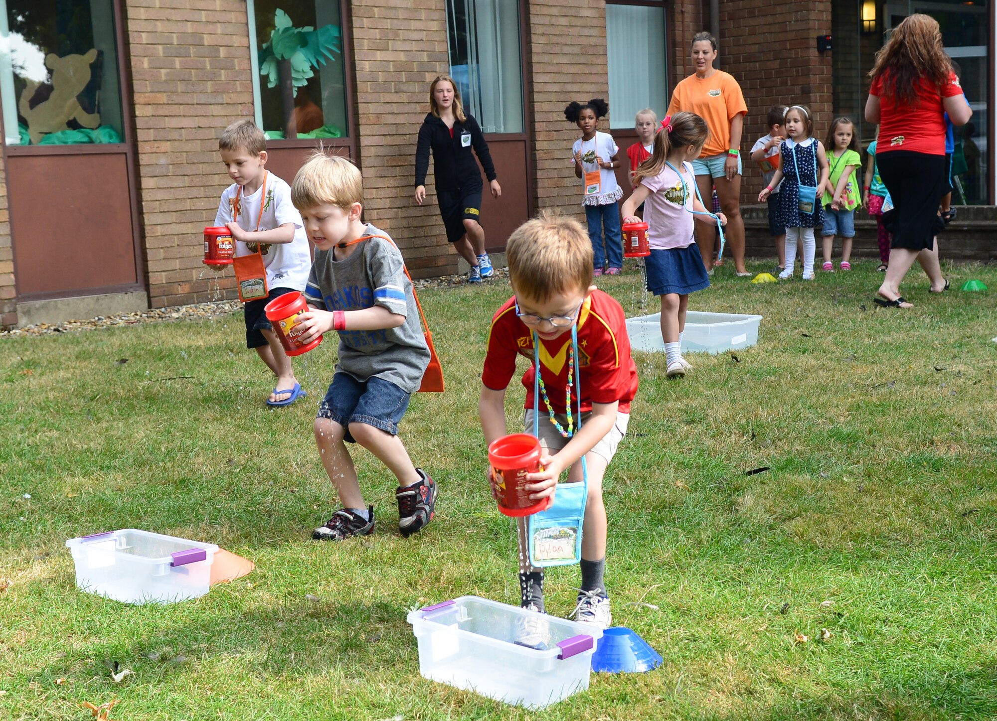 Team Mildenhall children compete in a relay Aug. 1, 2014, at Vacation Bible School at the base chapel on RAF Mildenhall, England. Throughout the week-long school children participated in a variety of activities including arts and crafts, relay races and song services. (U.S. Air Force photo/Airman 1st Class Jonathan Light/Released)
