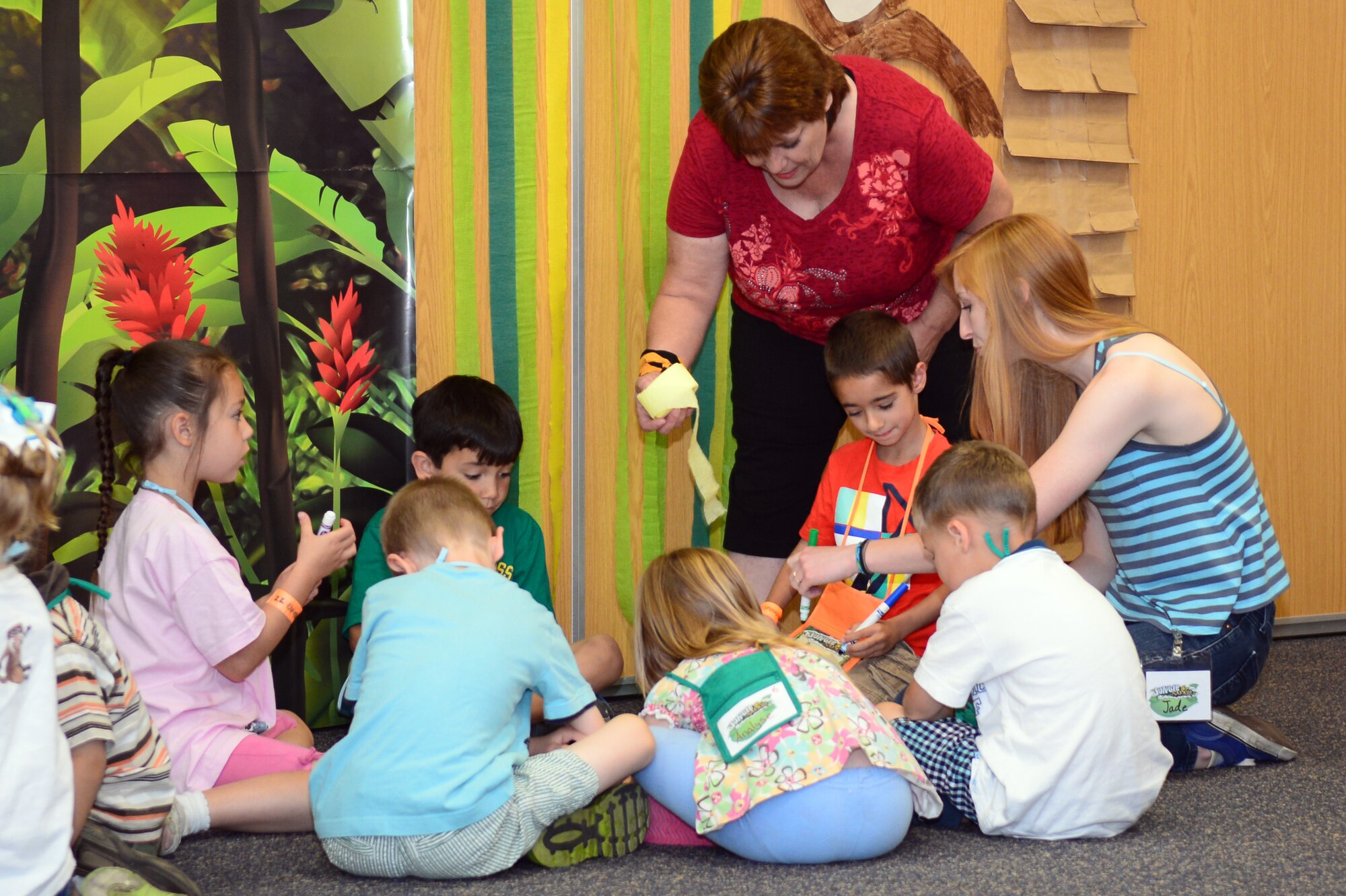 Volunteers for Vacation Bible School assist children with arts and crafts Aug. 1, 2014 at the base chapel on RAF Mildenhall, England. Bible school is a week-long annual event held for children ages 3 to 11. (U.S. Air Force photo/Airman 1st Class Jonathan Light/Released)