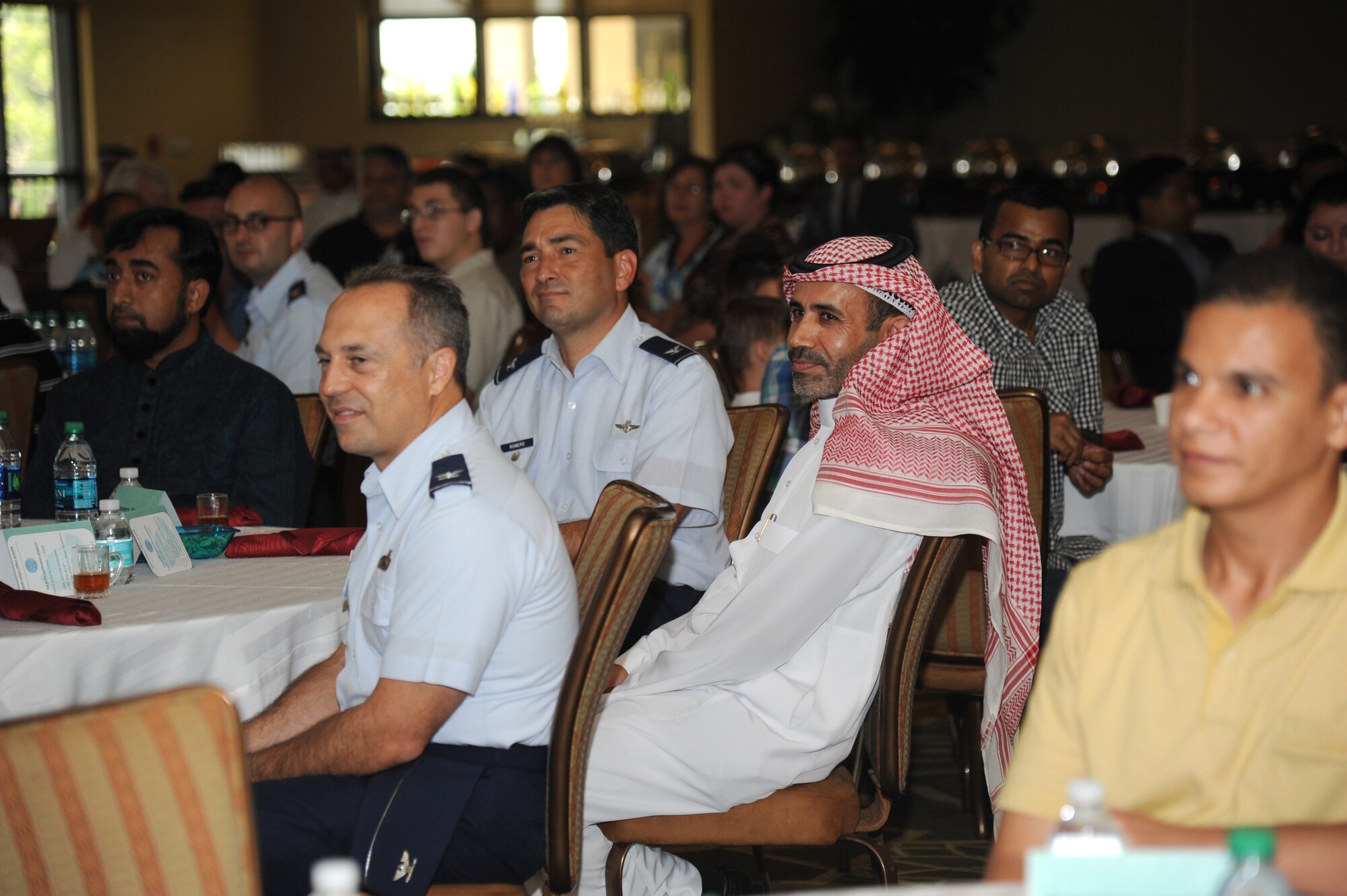Lt. Col. Alloush Al-Dosari, Royal Saudi Air Force country liaison officer, sits at the head table with Keesler leadership during a luncheon to celebrate Eid al-Fitr, July 28, 2014, at the Bay Breeze Event Center, Keesler Air Force Base, Miss. Ramadan is a month dedicated to worship and repentance. Muslims worldwide observe this month by fasting from dawn until sunset. Eid al-Fitr is a three-day celebration that marks the end of Ramadan. (U.S. Air Force photo by Kemberly Groue)