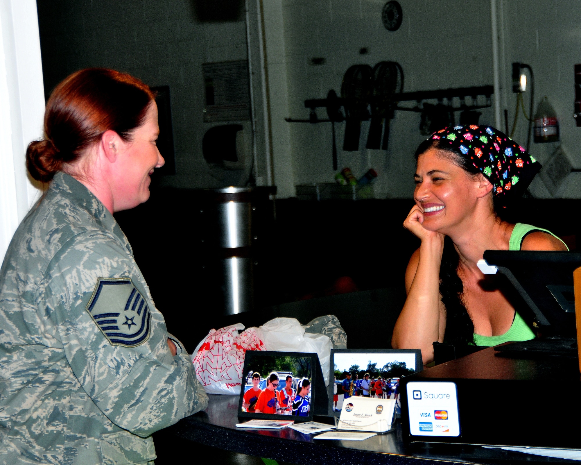 U.S Air Force Master Sgt. Jacqueline Adair, U.S. Strategic Command computer networking specialist, shares a laugh with Ayten Hooper, Smoothalicious owner and operator, June 6 at the Offutt Field House. Smoothalicious offers a variety of sandwiches, salads and their specialty, smoothies. (U.S. Air Force photo by D.P. Heard/Released)