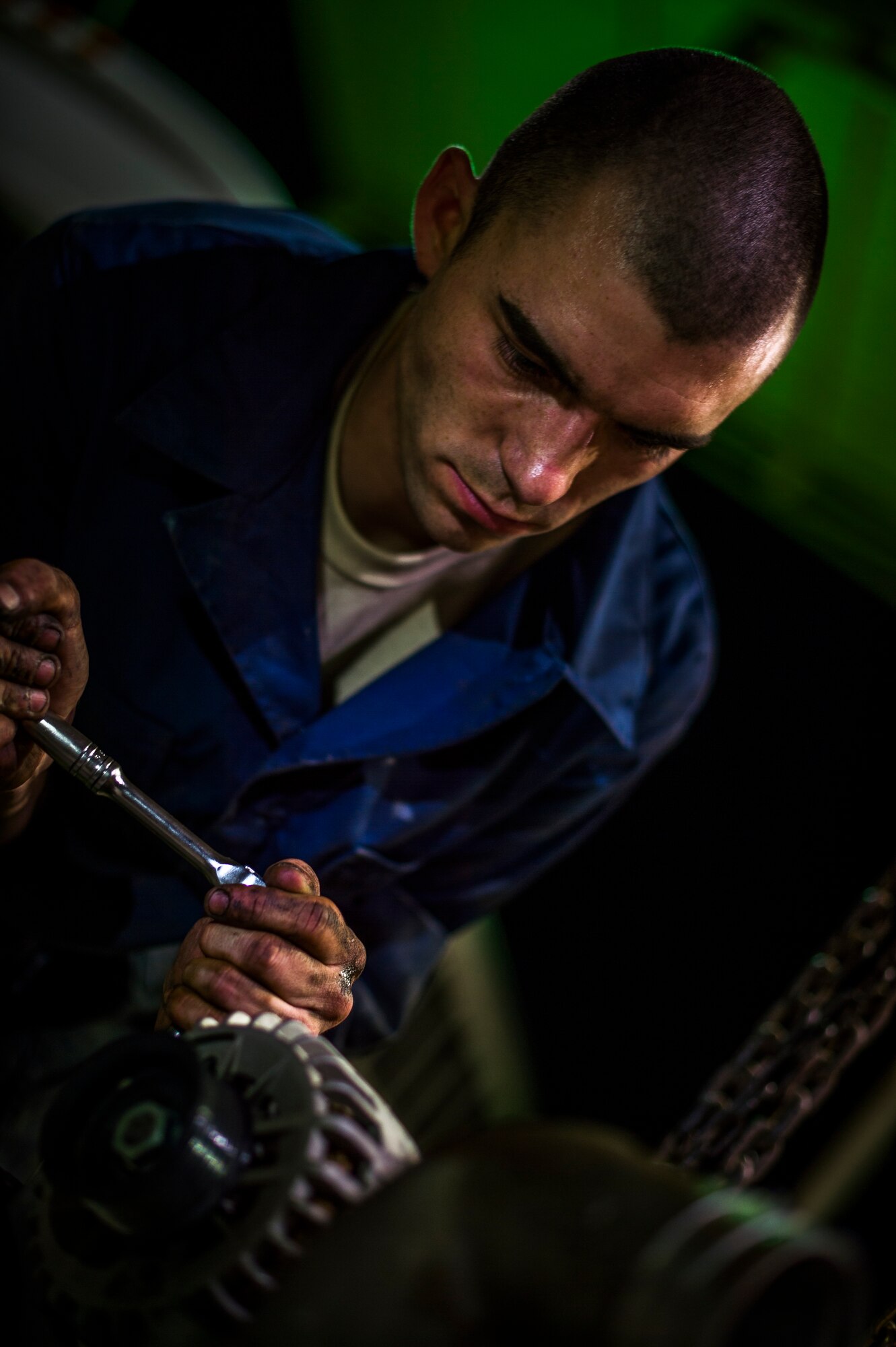 U.S. Air Force Senior Airman Christopher Moore, 386th Expeditionary Logistics Readiness Squadron vehicle mechanic, removes the engine of a truck July 18, 2014 at an undisclosed location in Southwest Asia. Moore has been a mechanic for the Air Force for three years and deployed from the 86th Vehicle Readiness Squadron, Ramstein Air Base, Germany in support of Operation Enduring Freedom. (U.S. Air Force photo by Staff Sgt. Jeremy Bowcock)
