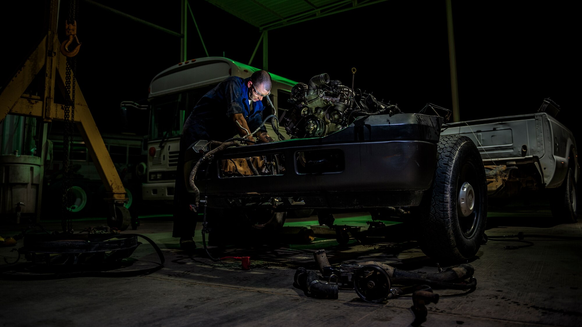 U.S. Air Force Senior Airman Christopher Moore, 386th Expeditionary Logistics Readiness Squadron vehicle mechanic, removes the engine of a truck July 18, 2014 at an undisclosed location in Southwest Asia. Moore has been a mechanic for the Air Force for three years and deployed from the 86th Vehicle Readiness Squadron, Ramstein Air Base, Germany in support of Operation Enduring Freedom. (U.S. Air Force photo by Staff Sgt. Jeremy Bowcock)

