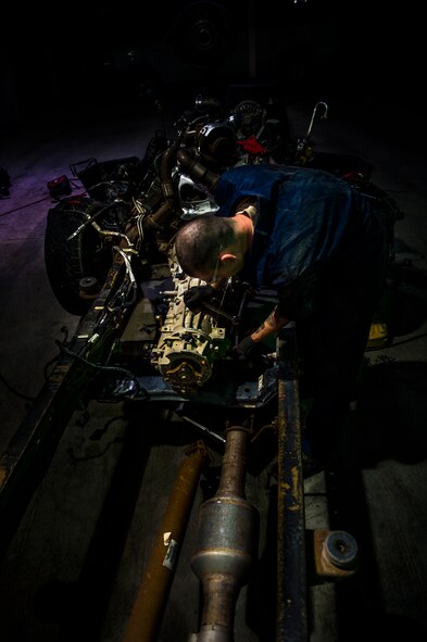 U.S. Air Force Senior Airman Christopher Moore, 386th Expeditionary Logistics Readiness Squadron vehicle mechanic, removes the engine of a truck July 18, 2014 at an undisclosed location in Southwest Asia. Moore has been a mechanic for the Air Force for three years and deployed from the 86th Vehicle Readiness Squadron, Ramstein Air Base, Germany in support of Operation Enduring Freedom. (U.S. Air Force photo by Staff Sgt. Jeremy Bowcock)
