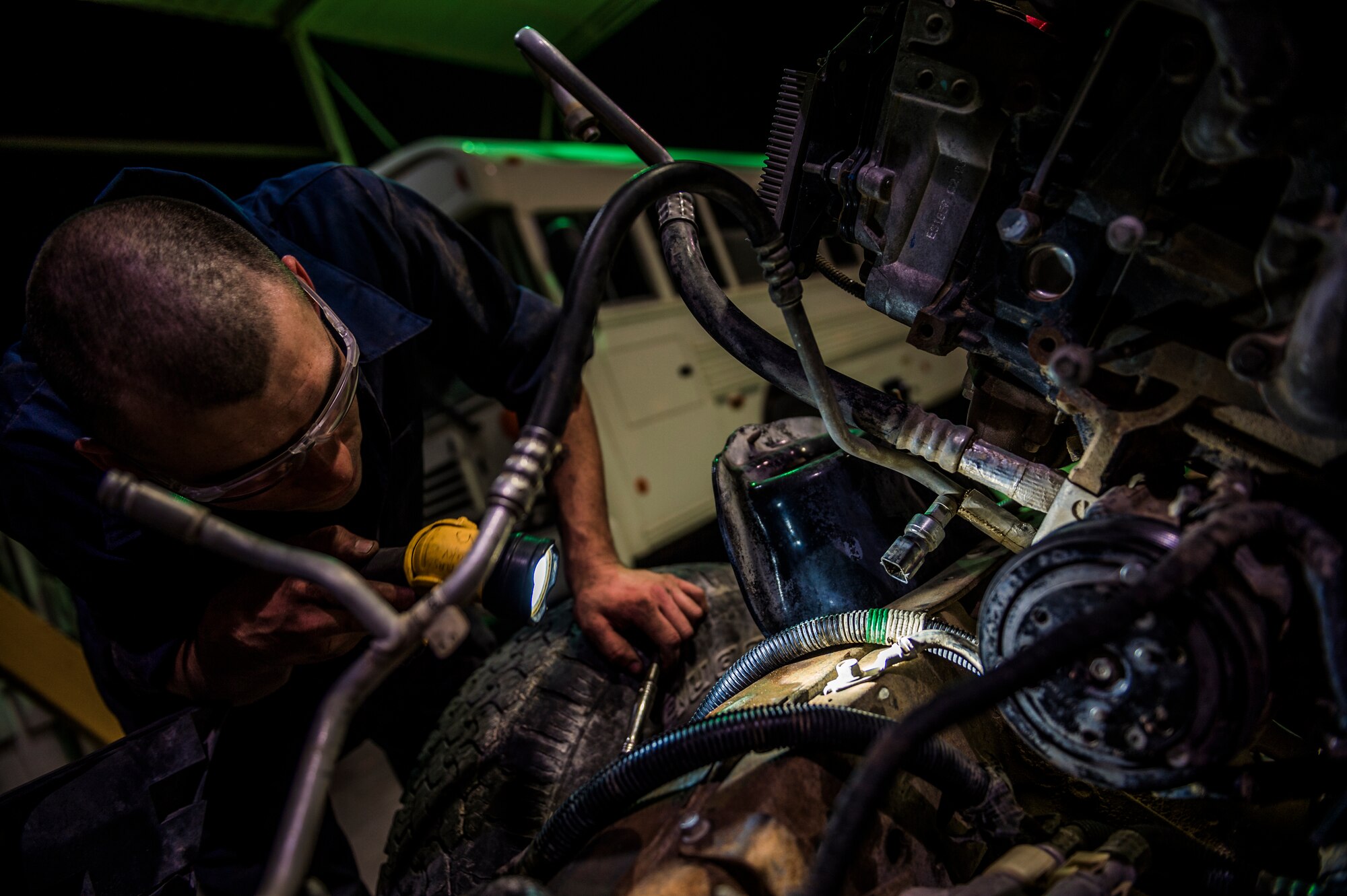 U.S. Air Force Senior Airman Christopher Moore, 386th Expeditionary Logistics Readiness Squadron vehicle mechanic, removes the engine of a truck July 18, 2014 at an undisclosed location in Southwest Asia. Moore has been a mechanic for the Air Force for three years and deployed from the 86th Vehicle Readiness Squadron, Ramstein Air Base, Germany in support of Operation Enduring Freedom. (U.S. Air Force photo by Staff Sgt. Jeremy Bowcock)
