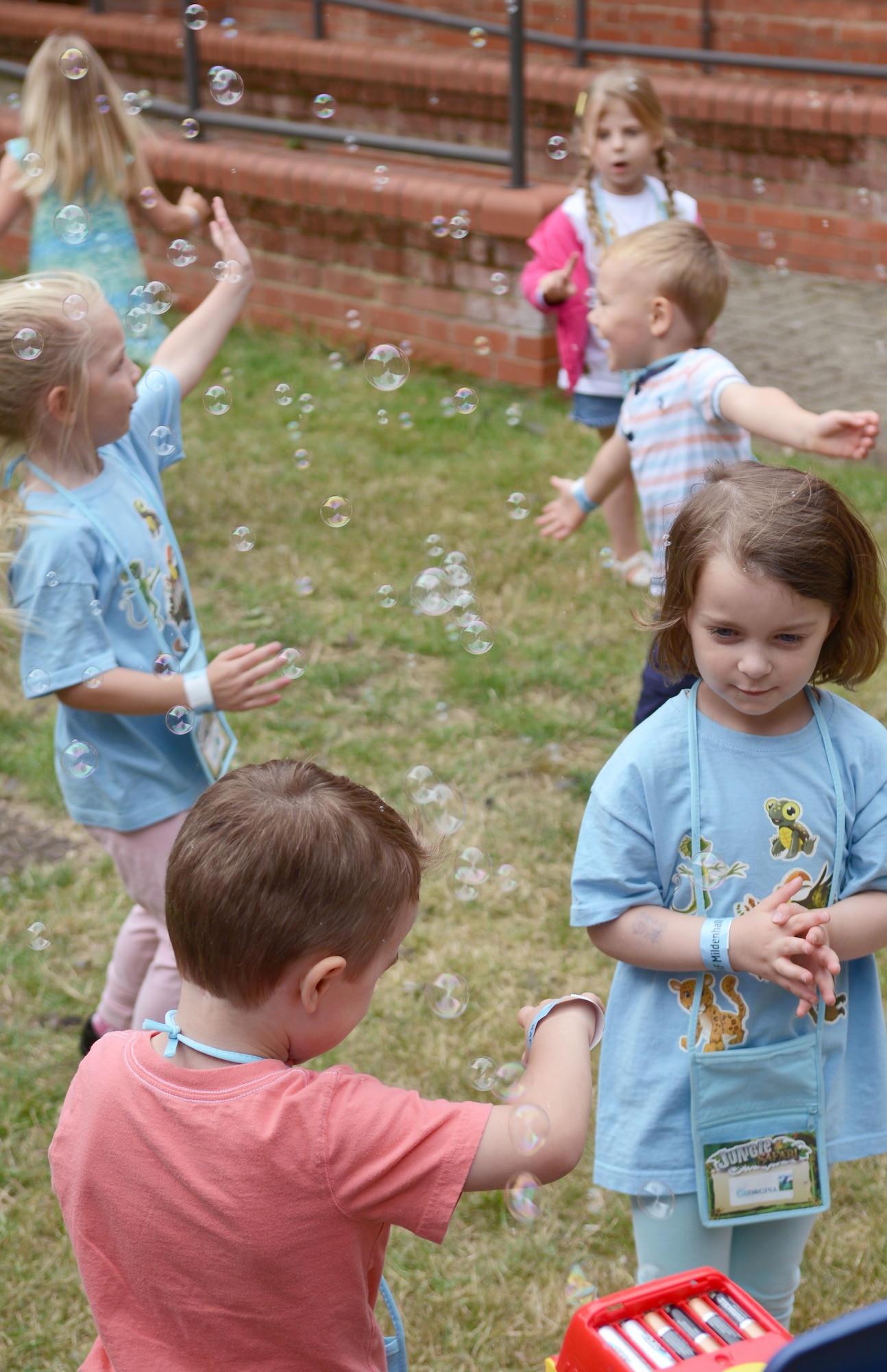 Team Mildenhall children play with bubbles during Vacation Bible School July 30, 2014, on RAF Mildenhall, England. Children who attend the program get to participate in games, outdoor activities and church-based learning courses. (U.S. Air Force photo/Airman 1st Class Dillon Johnston/Released)