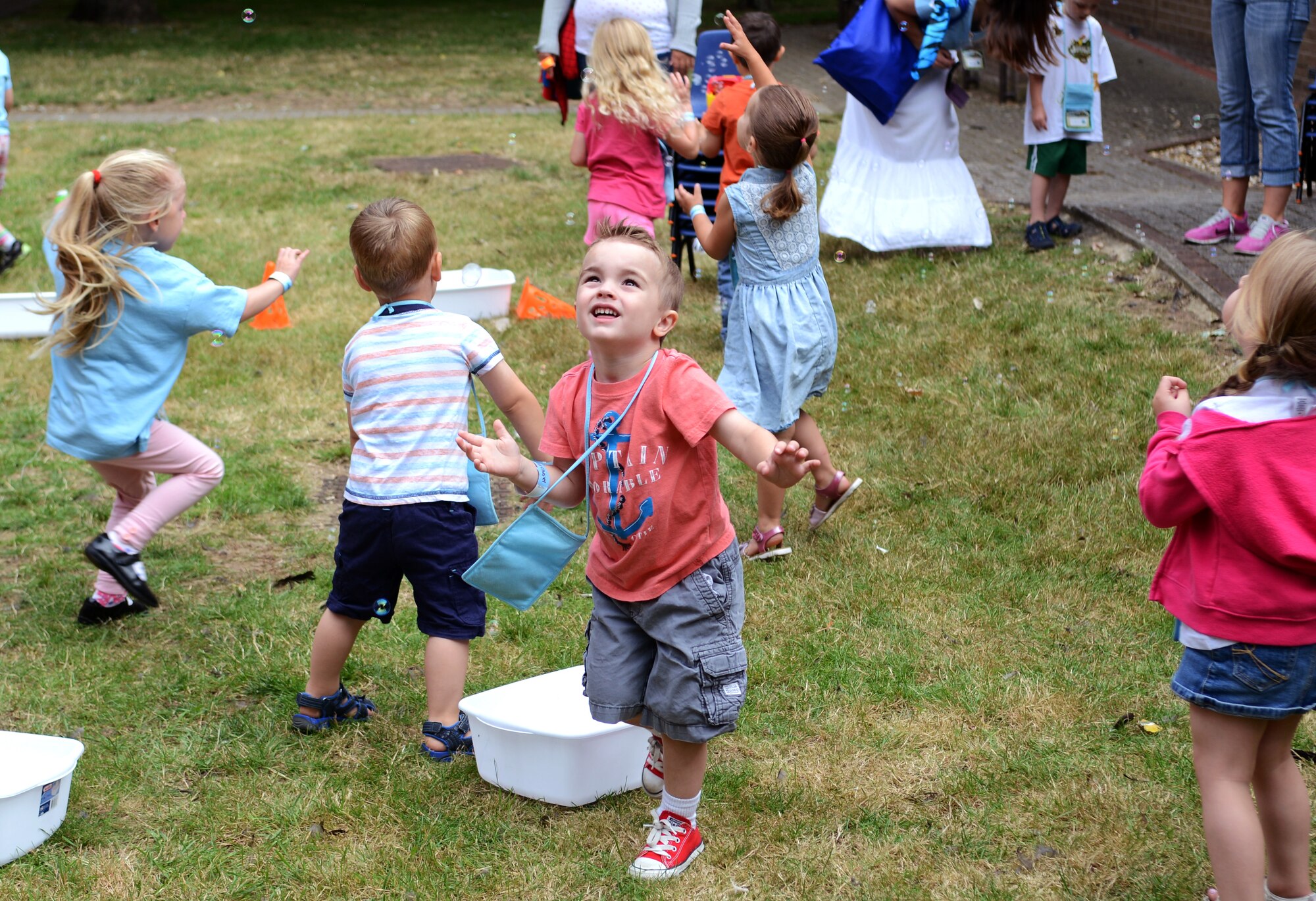 Team Mildenhall children chase after bubbles during Vacation Bible School July 30, 2014, on RAF Mildenhall, England. The bubble activities allowed children to get outside for some exercise and playtime in between different games and church-based learning courses. (U.S. Air Force photo/Airman 1st Class Dillon Johnston/Released)