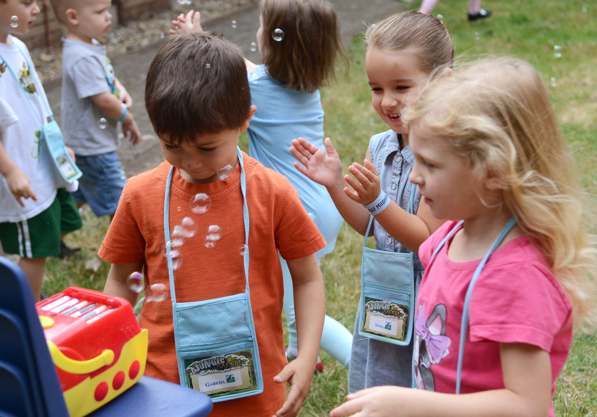 Team Mildenhall children get up close and personal with a bubble machine during Vacation Bible School July 30, 2014, on RAF Mildenhall, England. Children who attend the program get to participate in games, outdoor activities and church-based learning courses. (U.S. Air Force photo/Airman 1st Class Dillon Johnston/Released)