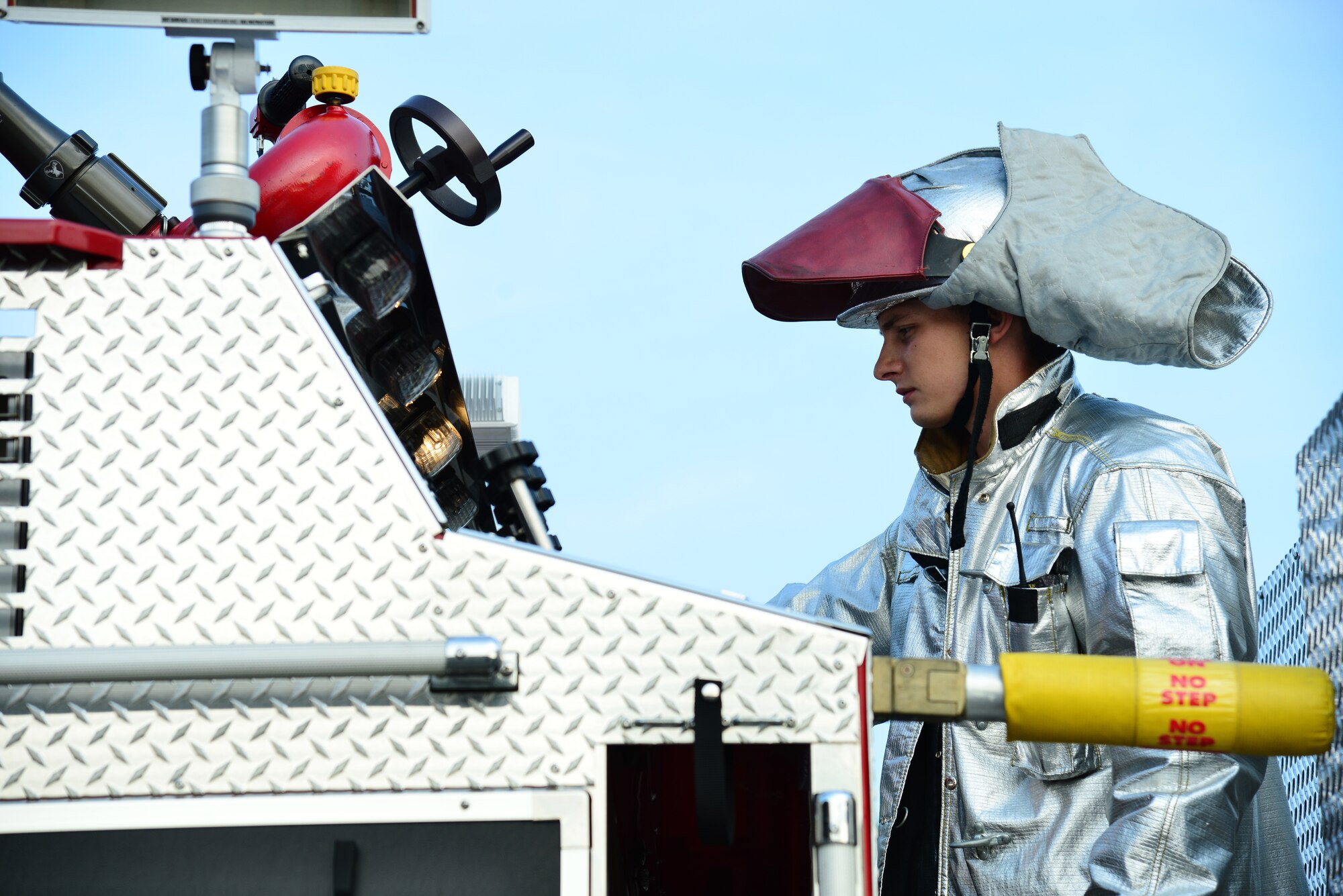 U.S. Air Force Senior Airman Jason Pincheon, 633rd Civil Engineer Squadron fire protection journeyman, runs a fire pump water supply during a simulated fuel spill exercise at Langley Air Force Base, Va., July 31, 2014. Fuel spill exercises are performed to ensure first-responders know the appropriate steps to contain a spill in case a real-world incident occurs. (U.S. Air Force photo by Senior Airman Aubrey White/Released)