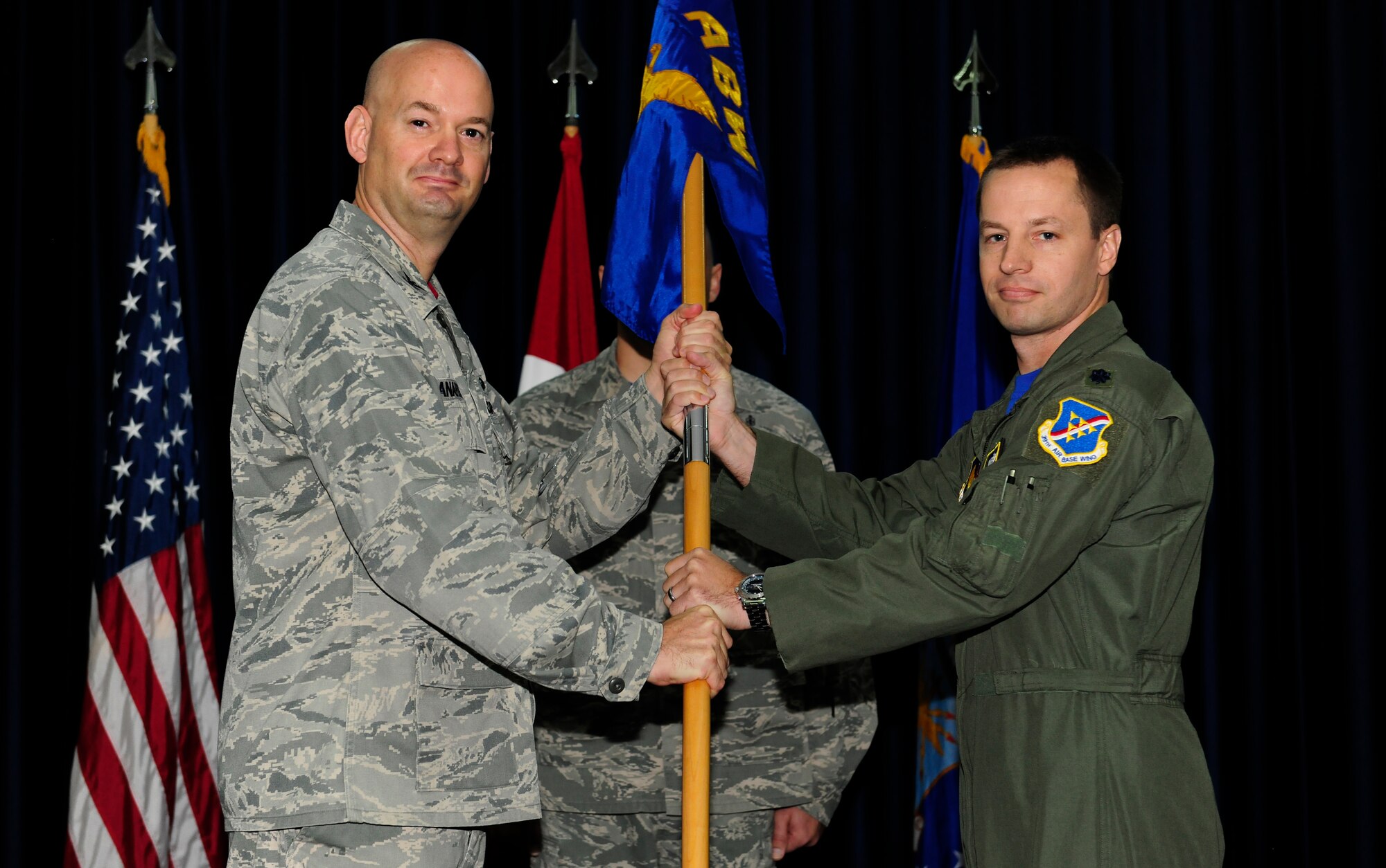 Col. Mark Anarumo, 39th Air Base Wing vice commander, passes the guidon to Lt. Col. Kyle Wilson, 39th Operations Support Squadron commander during a activation ceremony Aug 1, 2014, The passing of the guidon signified the assumption of command. (U.S. Air Force photo by Staff Sgt. Eboni Reams/Released)
