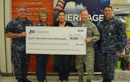 The Joint Base Charleston Navy Exchange recently concluded a fund raiser for the Navy and Marine Corps Relief Society, selling discount coupons which could be used for purchases and raising more than $9,325. Attending the ceremony were Capt. Timothy Sparks, Joint Base Charleston deputy commander, Beth Munoz, NEX general manager, Aurora Ramos, Mini-Mart manger, Col. Jeffrey DeVore, JB Charleston commander and Cmdr. David Tarwater, Naval Support Activity excecutive officer. (U.S. Air Force photo/Eric Sesit)

