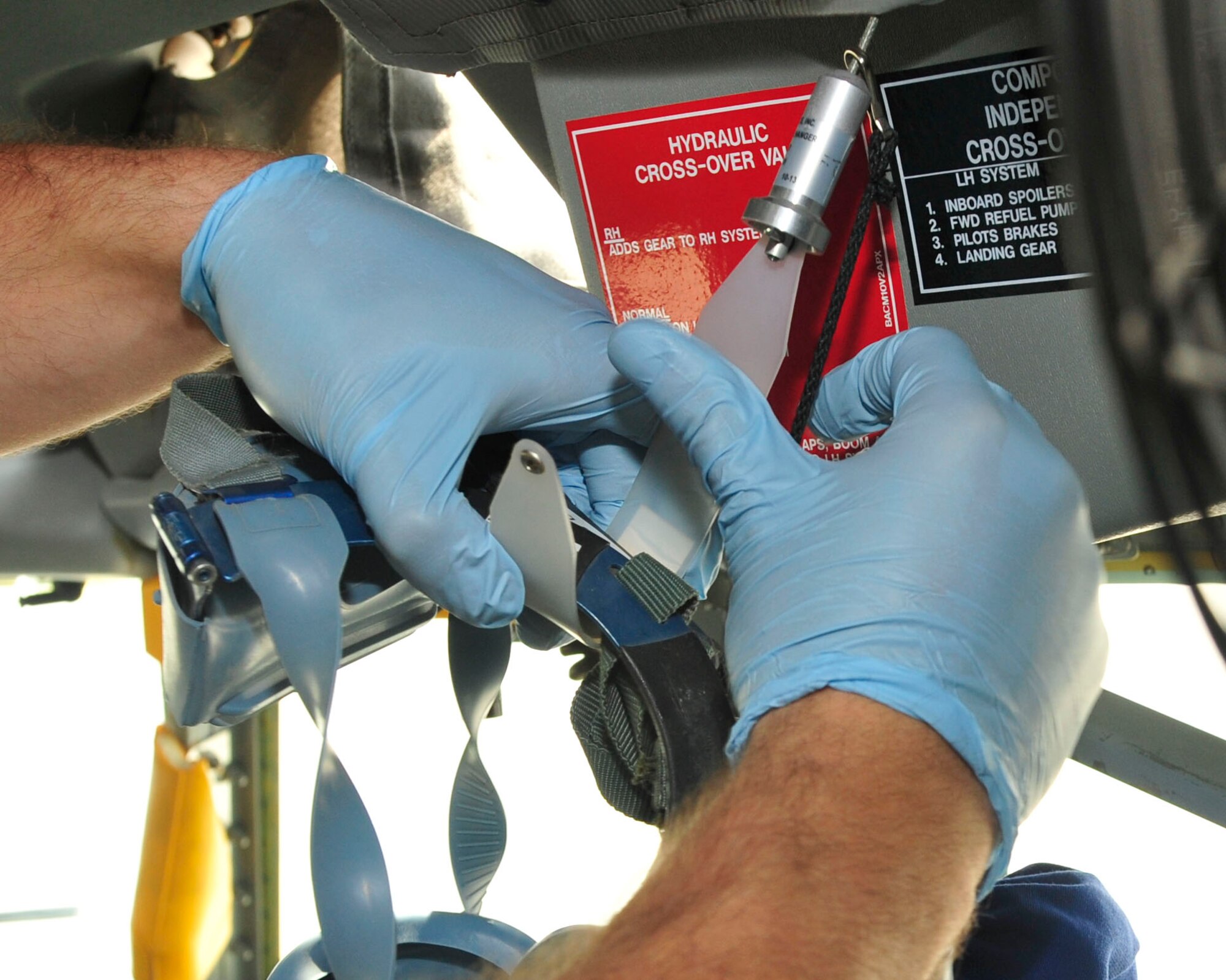 U.S. Air Force Senior Airman Kevin Robinson, 340th Expeditionary Air Refueling Squadron Detachment 1 aircrew flight equipment technician cleans equpiment after a refueling mission at Mazar-i-Sharif Air field, July 24, 2014. Maintaining the equipment is for it to be clean, safely functional and up todate . (U.S. Air Force photo by Senior Airman Colin Cates) 