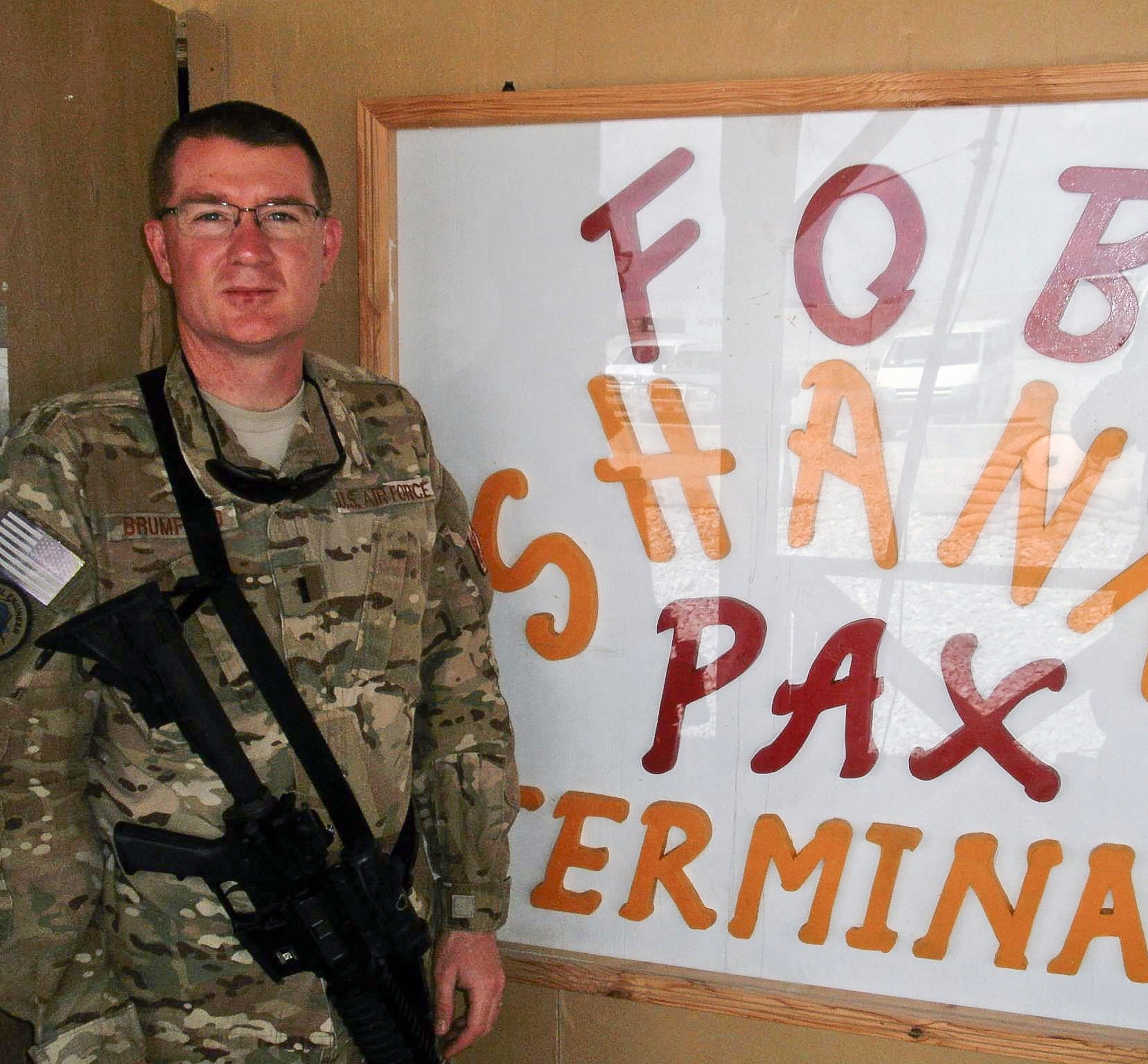 Then 1st Lt. Robert Brumfield, a 116th Air Control Wing operations officer, prepares to enter the passenger terminal at Forward Operating Base Shank en route to a mission in Eastern Afghanistan, July 19, 2012. (Courtesy photo)