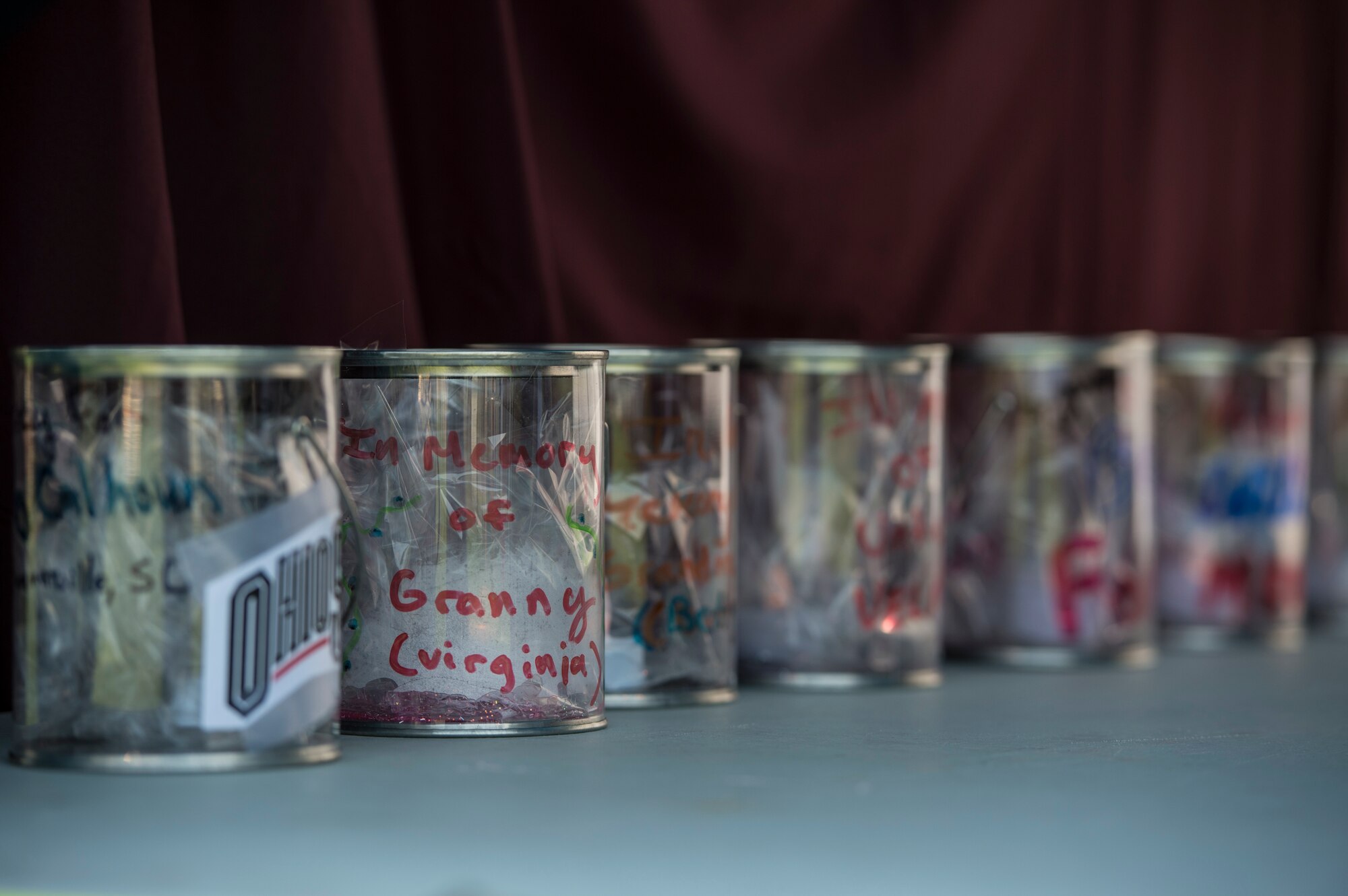 Memorial candles glow during the Relay For Life event on Spangdahlem Air Base, Germany, Aug. 1, 2014. Event organizers encouraged participants and spectators to place their own candle in the memorial tent or write on a provided mirror in memory of who may have died or survived the fight against cancer. (U.S. Air Force photo by Staff Sgt. Christopher Ruano/Released) 