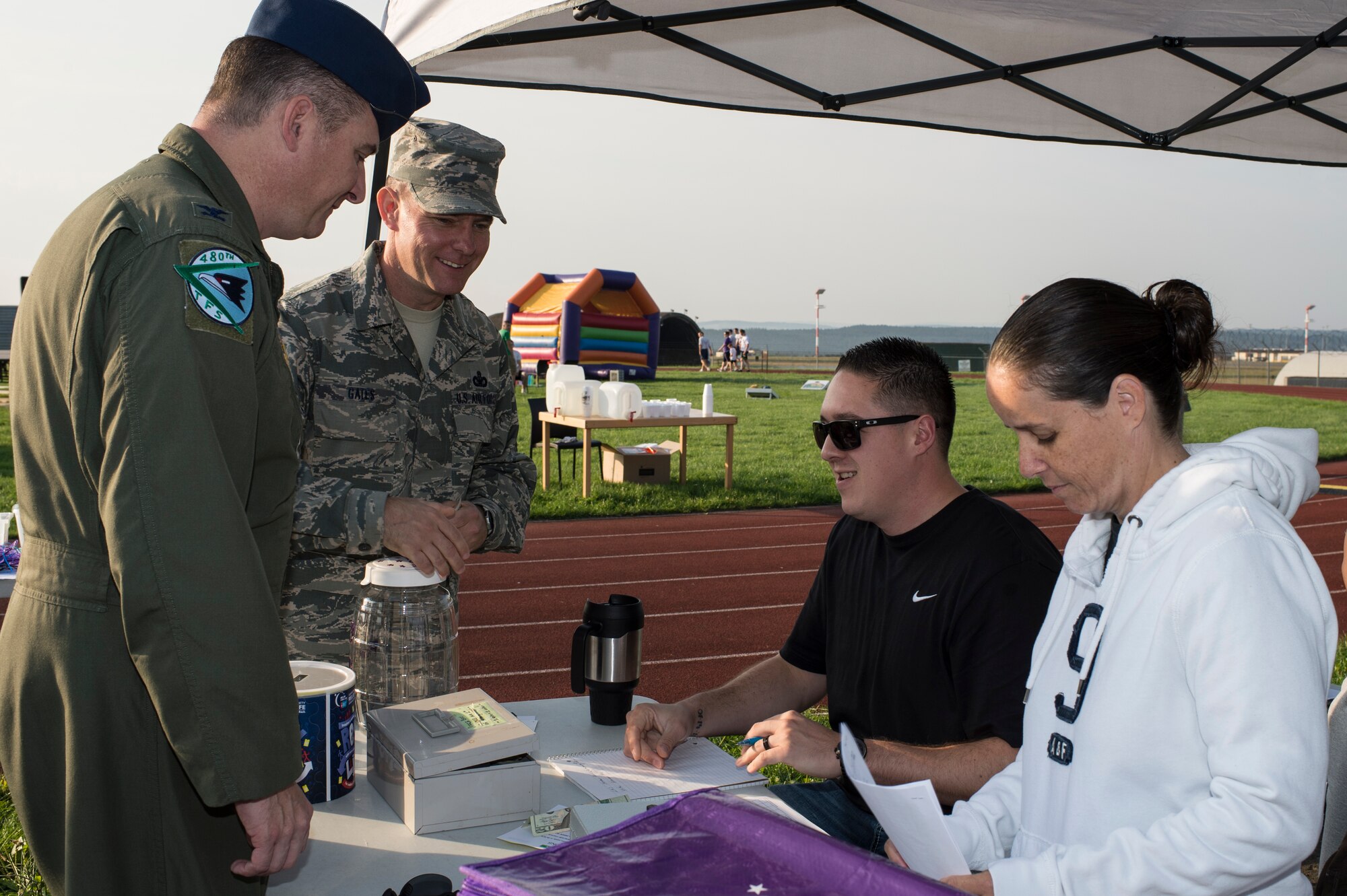 U.S. Air Force Col. Peter Bilodeau, 52nd Fighter Wing commander and U.S. Air Force Chief Master Sgt. Brian Gates, 52nd FW command chief, greets with Relay For Life volunteers at Spangdahlem Air Base, Germany, Aug. 1, 2014. The event raised awareness of base and national support groups dedicated to helping cancer survivors and their families. (U.S. Air Force photo by Staff Sgt. Christopher Ruano/Released)