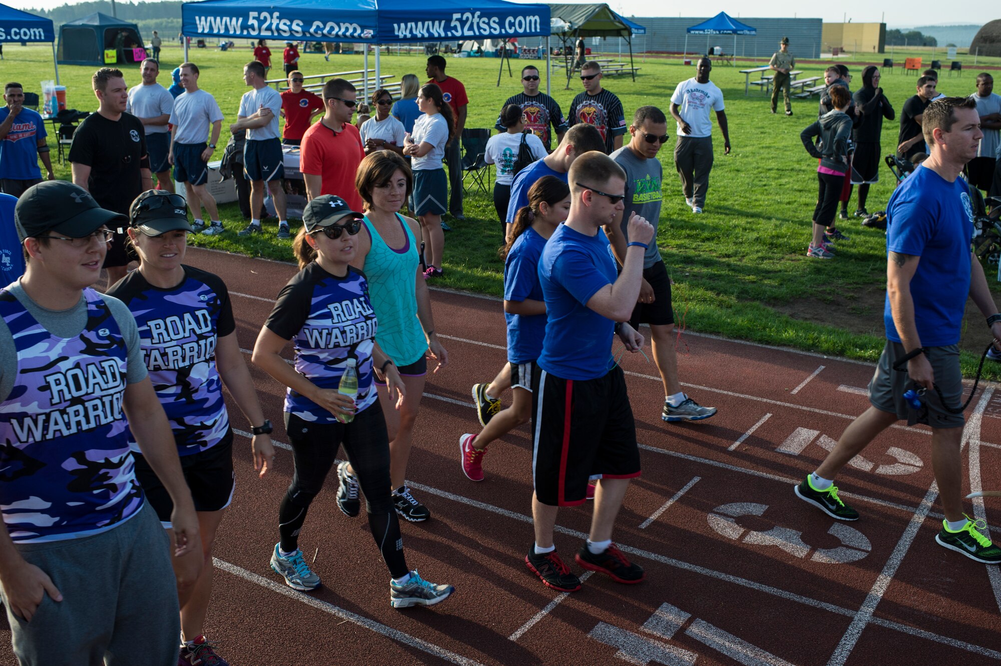 Relay For Life participants make their rounds on the base track at Spangdahlem Air Base, Germany, Aug. 1, 2014. Relay For Life teams require at least one member from the team to be on the track during the 12-hour event. (U.S. Air Force photo by Staff Sgt. Christopher Ruano/Released)