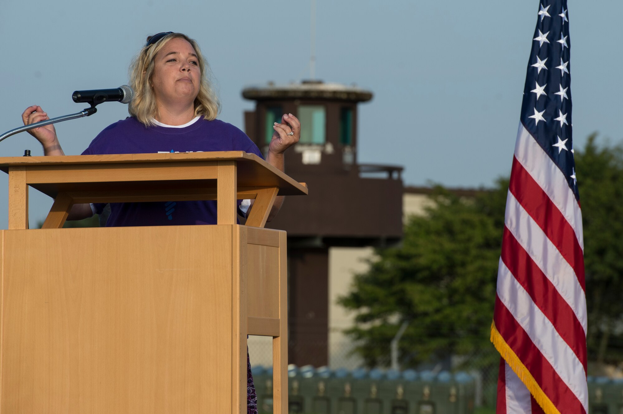 Amanda Atwell, cancer survivor and wife of U.S. Air Force Maj. Richard Atwell, 52nd Comptroller Squadron commander, speaks at the opening ceremony at the Relay For Life event at Spangdahlem Air Base, Germany, Aug. 1, 2014. The awareness event allowed participants to celebrate the lives of people who have battled cancer, remember loved ones lost and fight back against the disease. (U.S. Air Force photo by Staff Sgt. Christopher Ruano/Released)