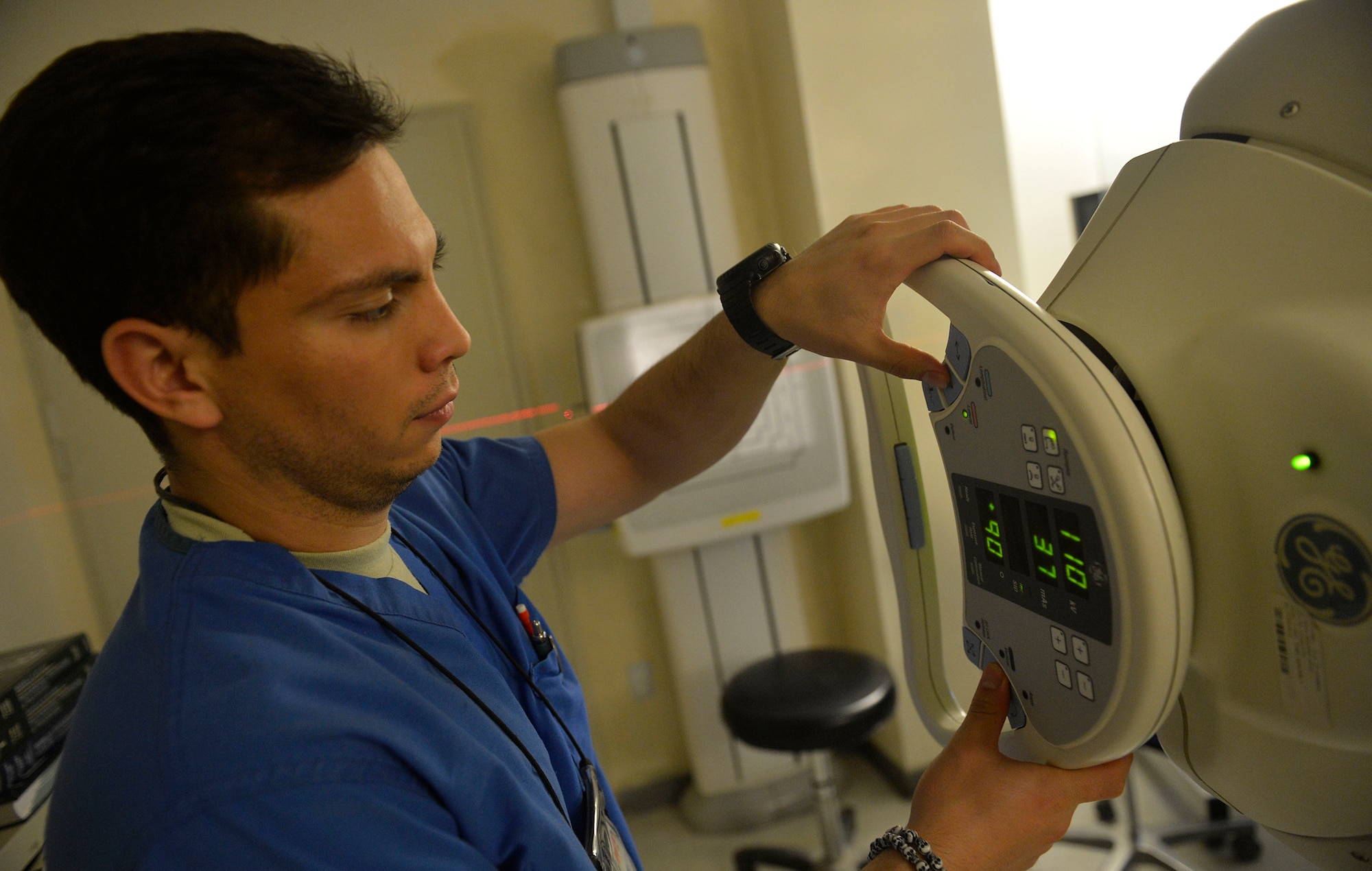 U.S. Air Force Senior Airman Freddy Toruno, 455th Expeditionary Medical Support Squadron diagnostic imaging technologist adjusts an x-ray machine for a patient at Craig Joint Theater Hospital at Bagram Airfield, Afghanistan July 27, 2014.  Diagnostic imaging techonologists average  40 exams a day, they work around the clock to provide diagnostic images for trauma and routine patients. Toruno is deployed from Travis Air Force Base, Calif. and a native of Miami, Fla.  (U.S. Air Force photo by Staff Sgt. Evelyn Chavez/Released)