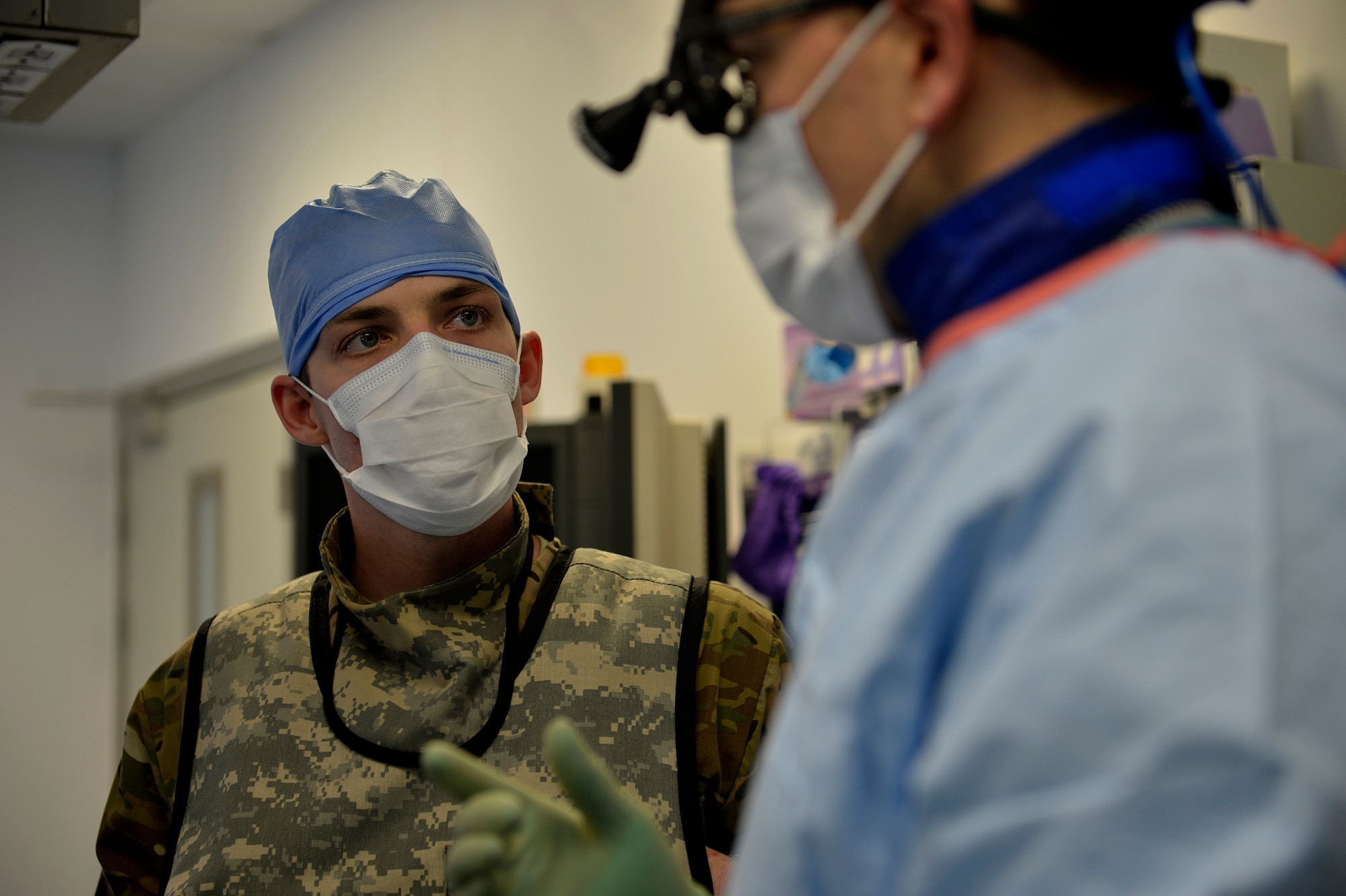 U.S. Air Froce Staff Sgt. Matthew Egts, 455th Expeditionary Medical Group diagnostic imaging technologist, speaks to a doctor during a surgery at Bagram Airfield, Afghanistan July 23, 2014.  As a diagnostic imaging technician, Egts can perform x-rays of the entire body in either surgical operating or imaging rooms.  Egts is deployed from Joint Base San Antonio, Texas and a native of San Antonio, Texas.  (U.S. Air Force photo by Staff Sgt. Evelyn Chavez/Released) 