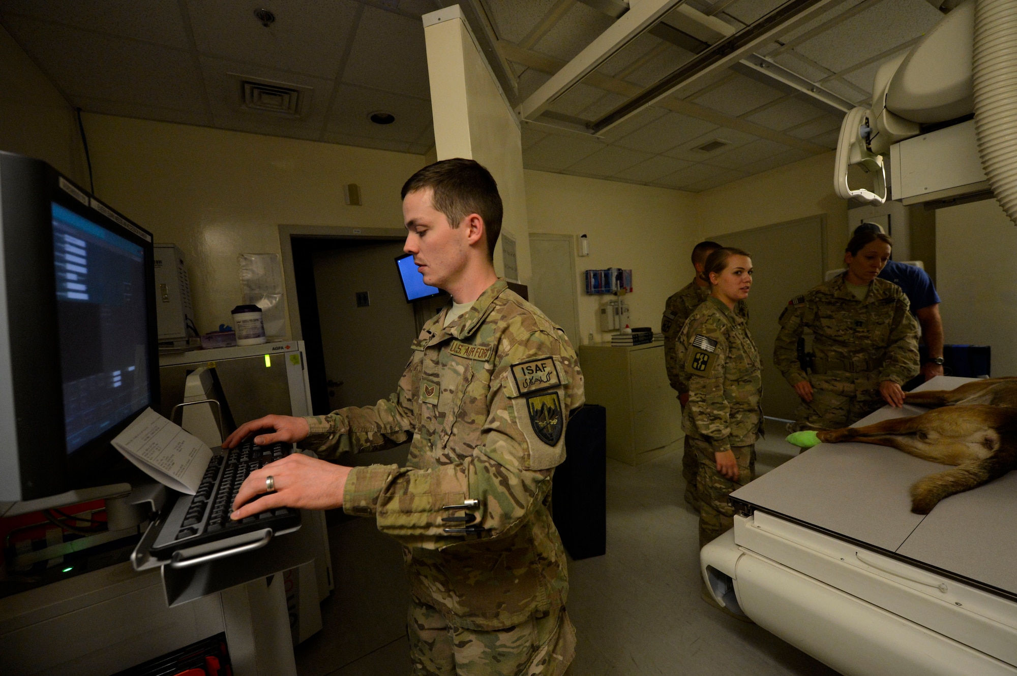 U.S. Air Force Staff Sgt. Matthew Egts, 455th Expeditionary Medical Support Squadron diagnostic imaging technologist, prepares an x-ray for a military working dog at Bagram Airfield, Afghanistan July 23,2014.  Egts is part of the eight-person Radiology team at Bagram who provide diagnostic imagery for routine and trauma patients around the clock. Egts is deployed from Joint Base San Antonio, Texas and a native of San Antonio, Texas.  (U.S. Air Force photo by Staff Sgt. Evelyn Chavez/Released) 