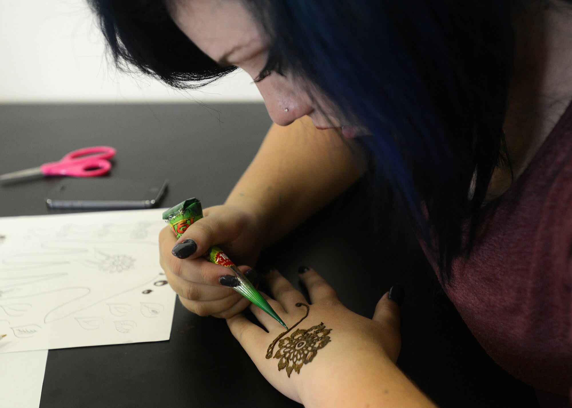 McKenzie Milligan practices henna design during a henna art class, July 31.2014, at Aviano Air Base, Italy. The Arts and Craft Center offers various classes in addition to craft supplies such as scrapbooks, fabrics, yarn and jewelry. (U.S. Air Force photo/Airman 1st Class Deana Heitzman)  