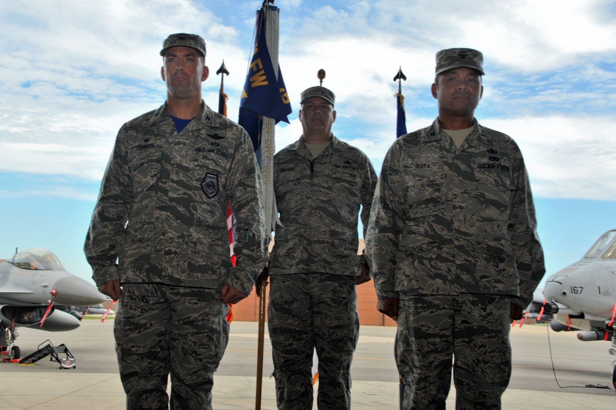 Col. Victor Mora, new 51st Maintenance Group commander, prepares to receive the guidon flag of the 51 MXG from Col. Brook Leonard, 51st Fighter Wing commander, during an assumption of command ceremony Aug. 1, 2014, at Osan Air Base, Republic of Korea. The passing of the flag symbolizes the passing of authority to the incoming commander. (U.S. Air Force photo by Senior Airman Matthew Lancaster)