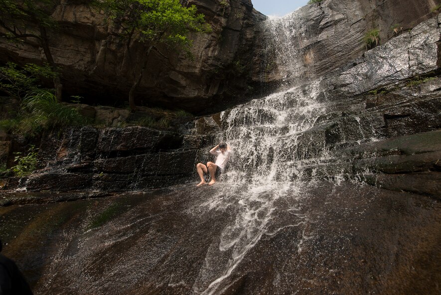 A person douses themself under a waterfall July 27, 2014, in Chungju, Republic of Korea. The waterfall is located in one of many outdoor parks in Chungju, a popular Summer activity is swimming in the outdoor creeks and pools. (U.S. Air Force photo by Staff Sgt. Jake Barreiro) 

